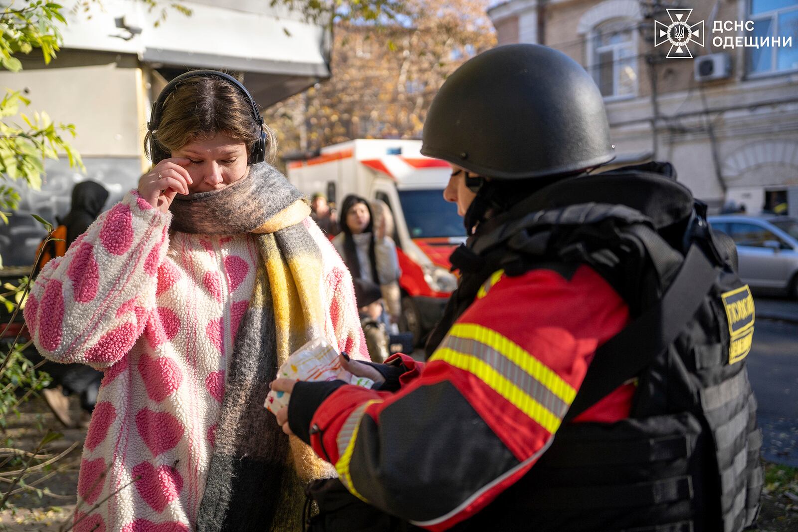 In this photo provided by the Ukrainian Emergency Services on Nov. 25, 2024, a rescue worker provides a medical help to a woman after a Russian strike on a residential neighbourhood in Odesa, Ukraine. (Ukrainian Emergency Service via AP)