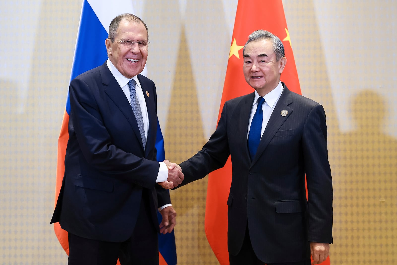 In this photo released by Russian Foreign Ministry Press Service, Russia's Foreign Minister Sergey Lavrov, left, and Chinese Foreign Minister Wang Yi pose for a photo on the sidelines of the G20 Summit leaders meeting in Rio de Janeiro, on Tuesday, Nov. 19, 2024. (Russian Foreign Ministry Press Service via AP)