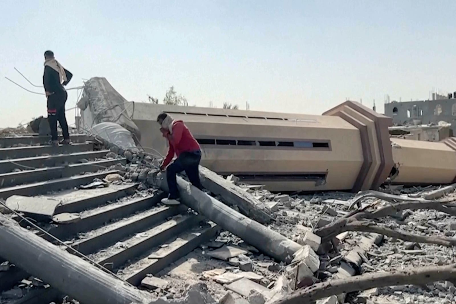 People observe a mosque destroyed by Israeli airstrikes in the city of Khan Younis, sothern Gaza Strip, Friday, Oct. 25, 2024. (AP Photo)