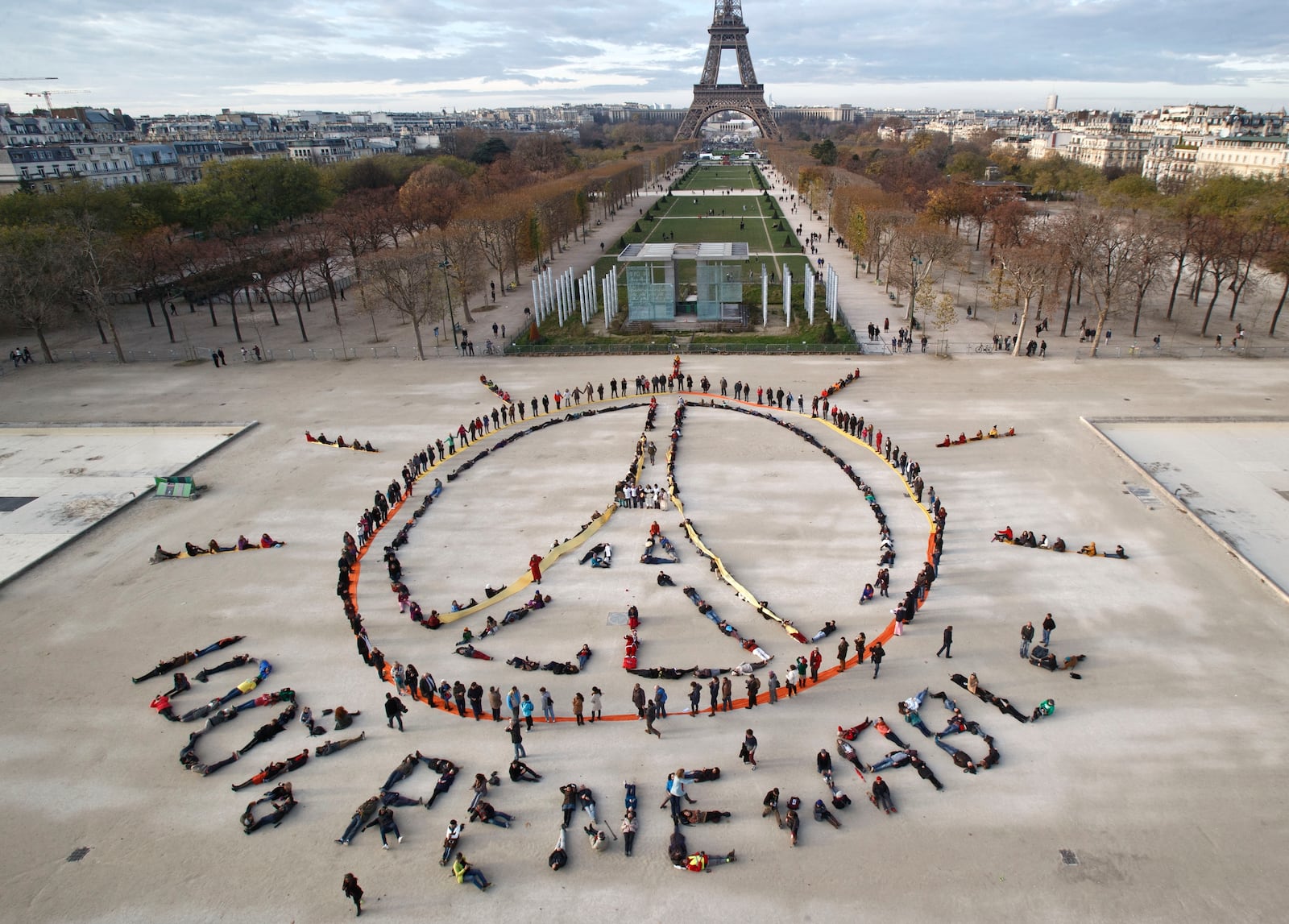 FILE - Environmentalist activists form a human chain representing the peace sign and the spelling out "100% renewable", on the side line of the COP21, United Nations Climate Change Conference near the Eiffel Tower in Paris on Dec. 6, 2015. (AP Photo/Michel Euler, File)