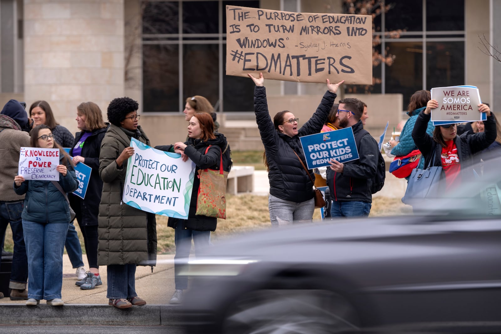 Protestors gather during a demonstration at the headquarters of the Department of Education, Friday, March 14, 2025, in Washington. (AP Photo/Mark Schiefelbein)