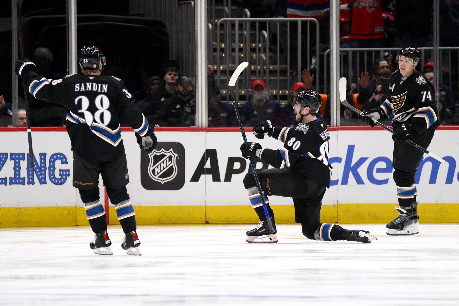 Washington Capitals left wing Pierre-Luc Dubois (80) celebrates after his goal with defenseman Rasmus Sandin (38) and defenseman John Carlson (74) during the second period of an NHL hockey game against the Winnipeg Jets, Saturday, Feb. 1, 2025, in Washington. (AP Photo/Nick Wass)