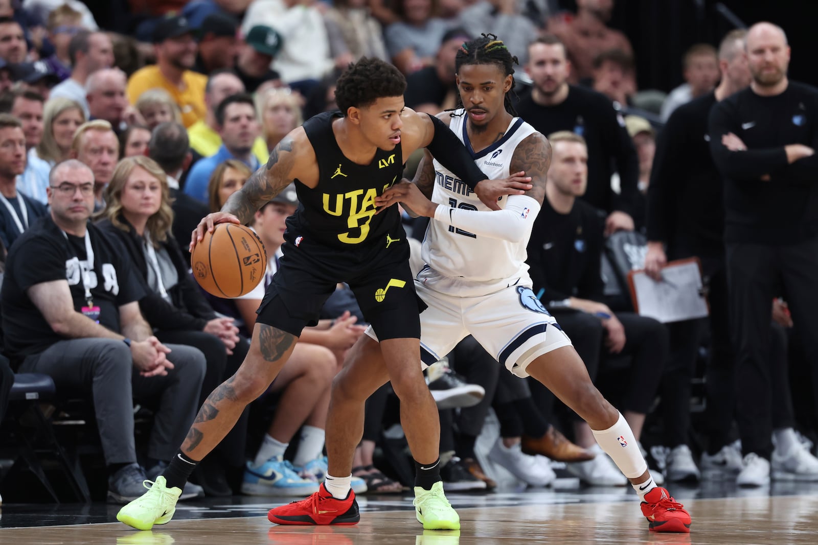 Utah Jazz guard Keyonte George (3) dribbles the ball while Memphis Grizzlies guard Ja Morant (12) defends during the first half of an NBA basketball game, Wednesday, Oct. 23, 2024, in Salt Lake City. (AP Photo/Rob Gray)