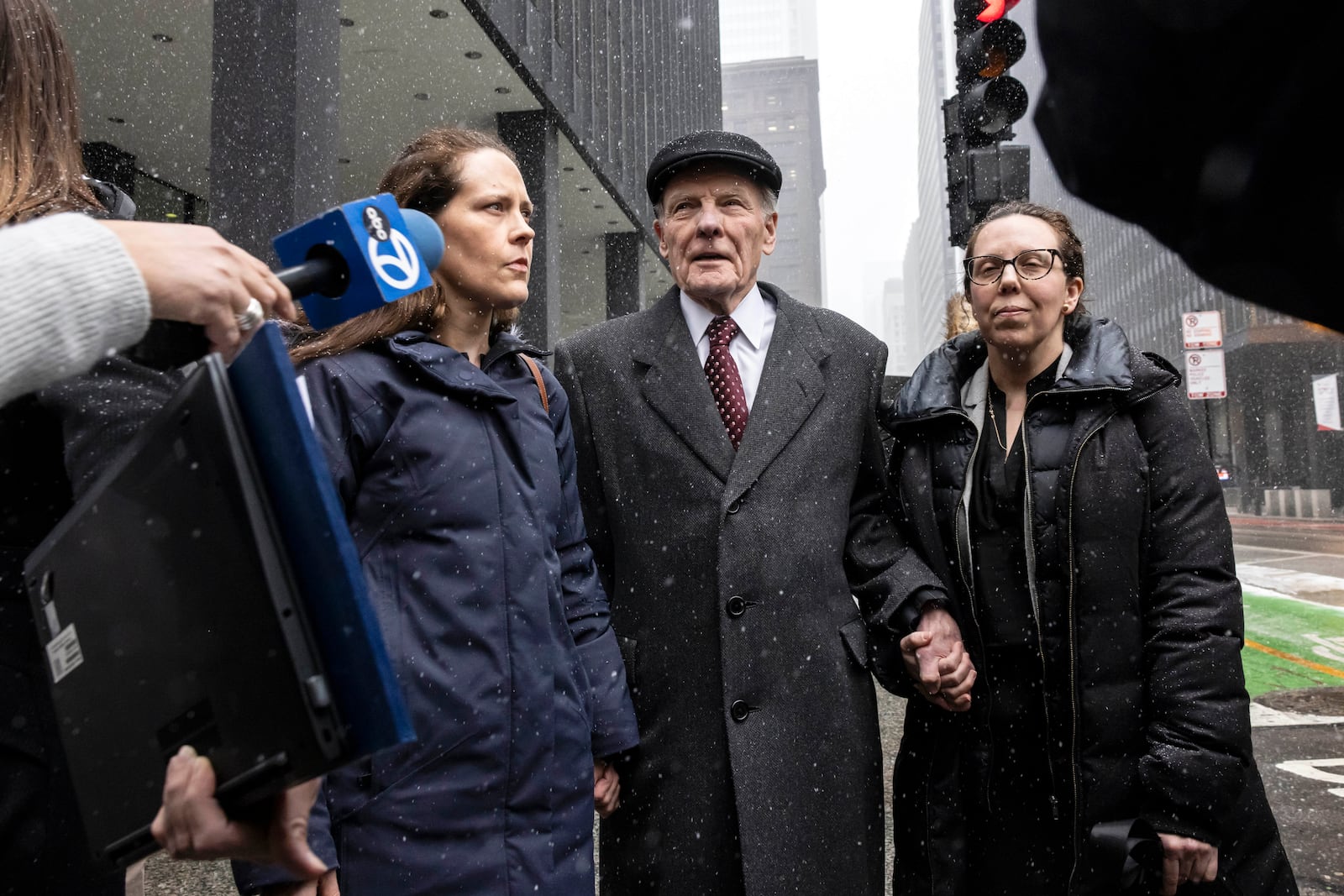 Flanked by supporters and holding hands with his daughter Nicole, former Illinois House Speaker Michael Madigan walks out of the Dirksen Federal Courthouse in Chicago, Wednesday, Feb. 12, 2025. (Ashlee Rezin/Chicago Sun-Times via AP)