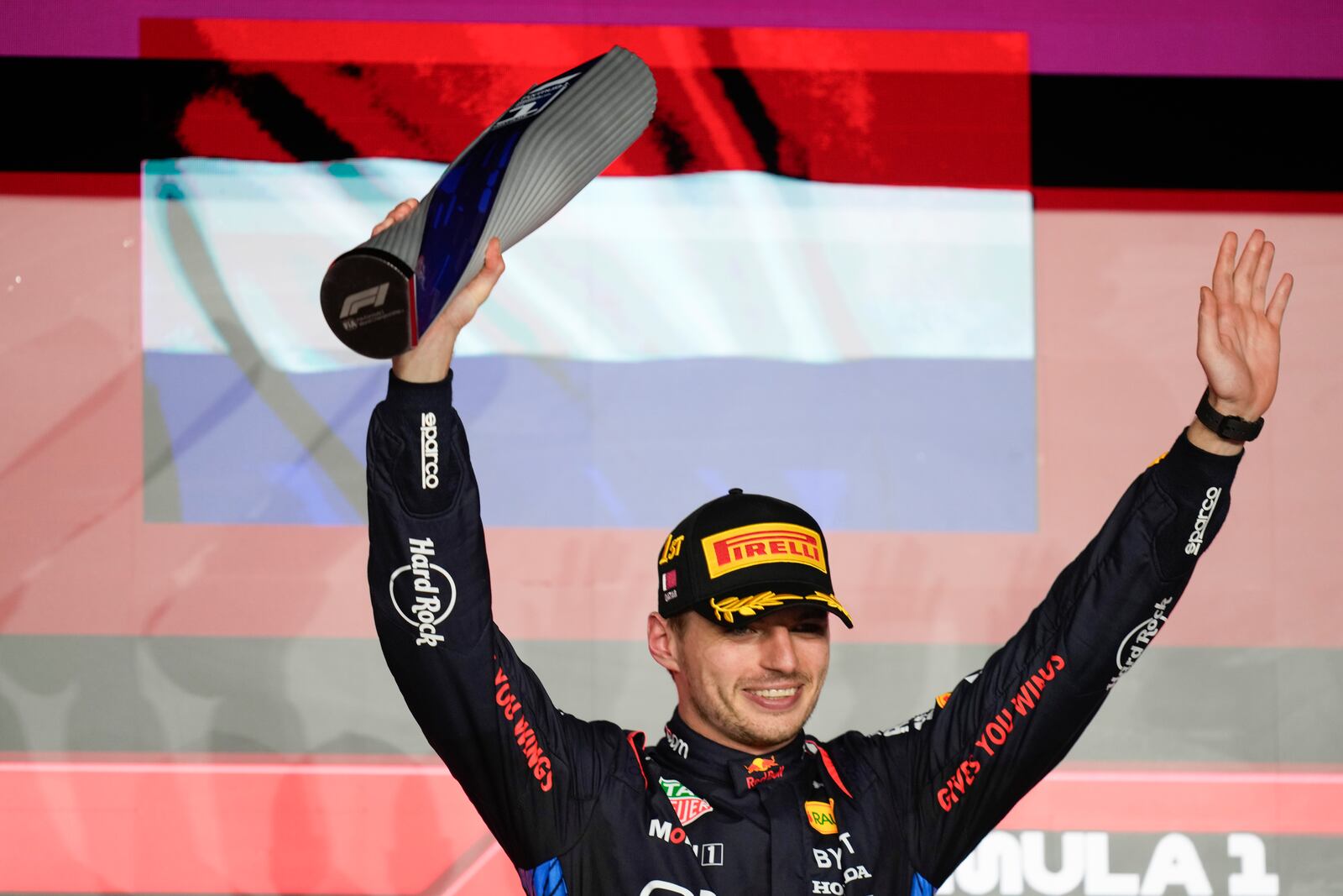 Red Bull driver Max Verstappen of the Netherlands stands on the podium after winning the Qatar Formula One Grand Prix at the Lusail International Circuit in Lusail, Qatar, Sunday, Dec. 1, 2024. (AP Photo/Darko Bandic)