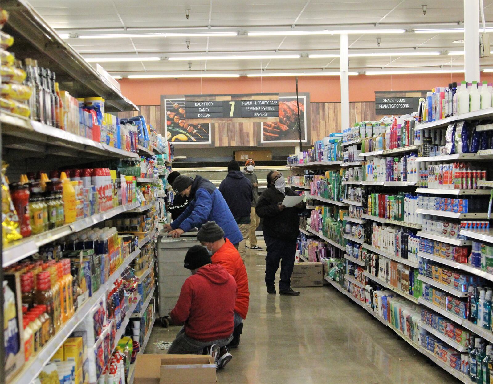 Cashiers and other employees at Groceryland prepare the store early December for its opening. The grocery is located at the former Kroger building on South Limestone Street. Hasan Karim/Staff