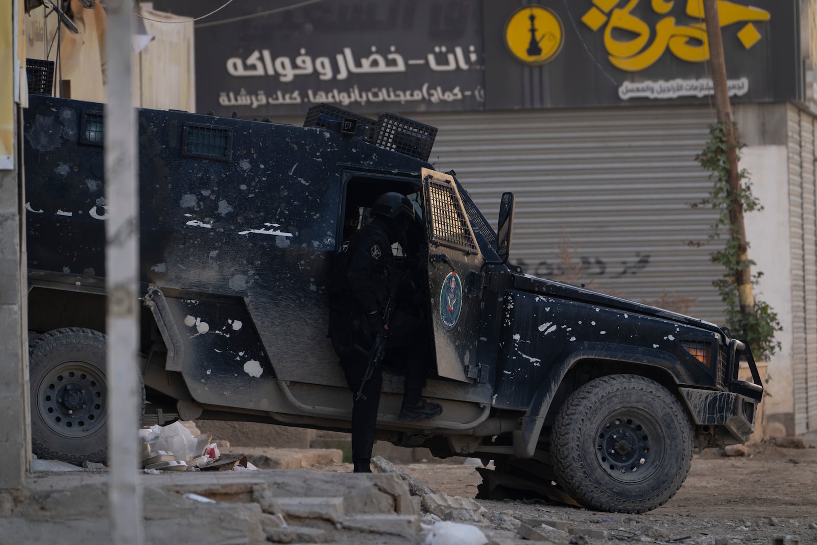 Armored Palestinian security vehicles are seen on the road as Palestinian forces mount a major raid against militants in the Jenin refugee camp in the Israeli-occupied West Bank, Monday, Dec. 23, 2024. (AP Photo/Majdi Mohammed)