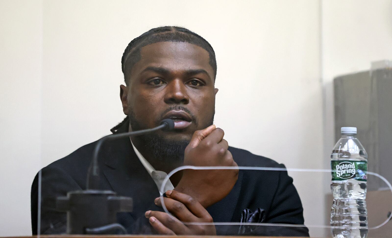 New England Patriots safety Jabrill Peppers shows hows his accuser grabbed his wrist as he testifies in his assault and battery trial, Friday, Jan. 23, 2025, in Quincy, Mass. (David L. Ryan/The Boston Globe via AP, Pool)