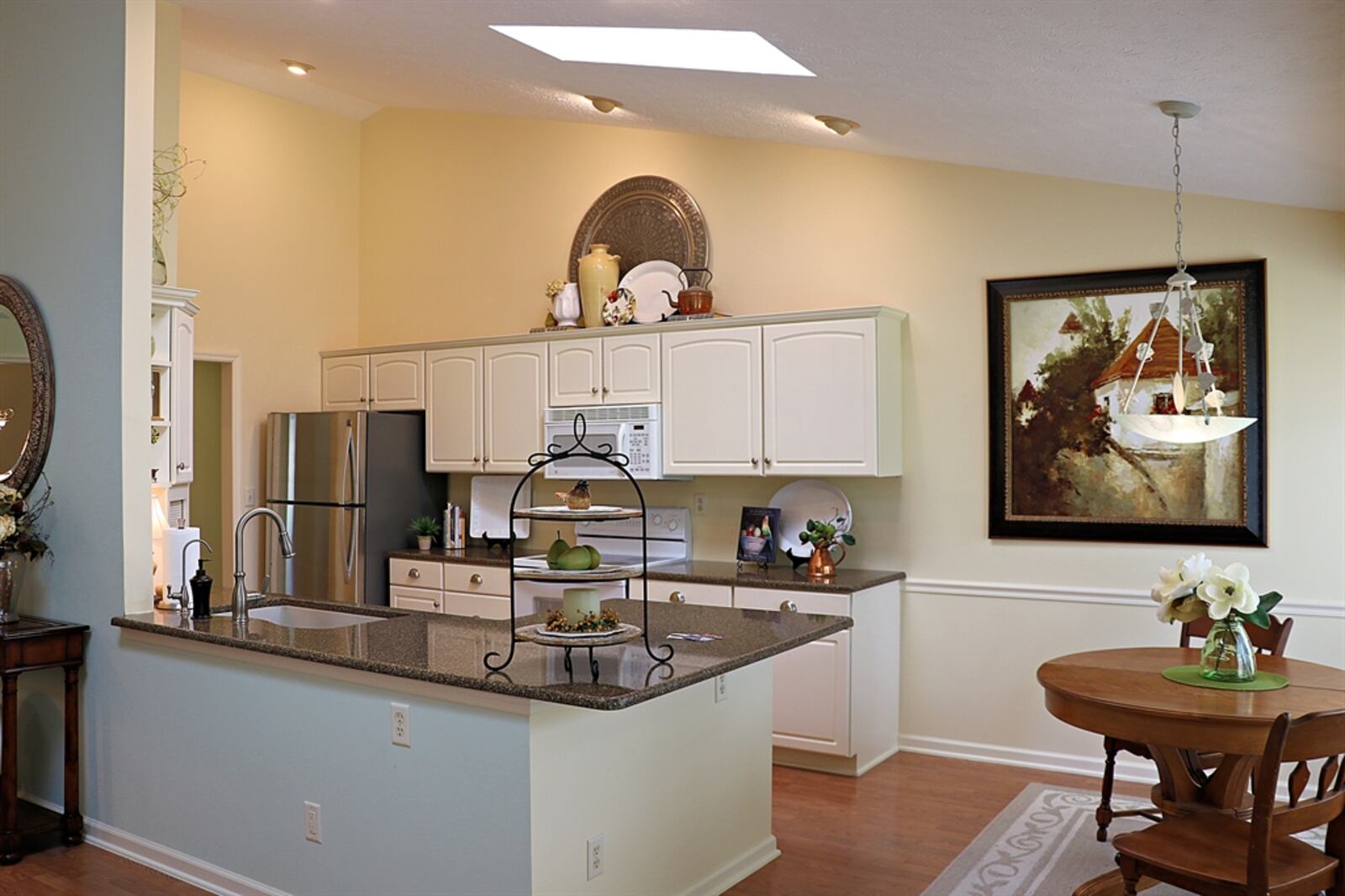 A peninsula counter wraps around the kitchen and has an extended counter for bar seating and extra workspace. 