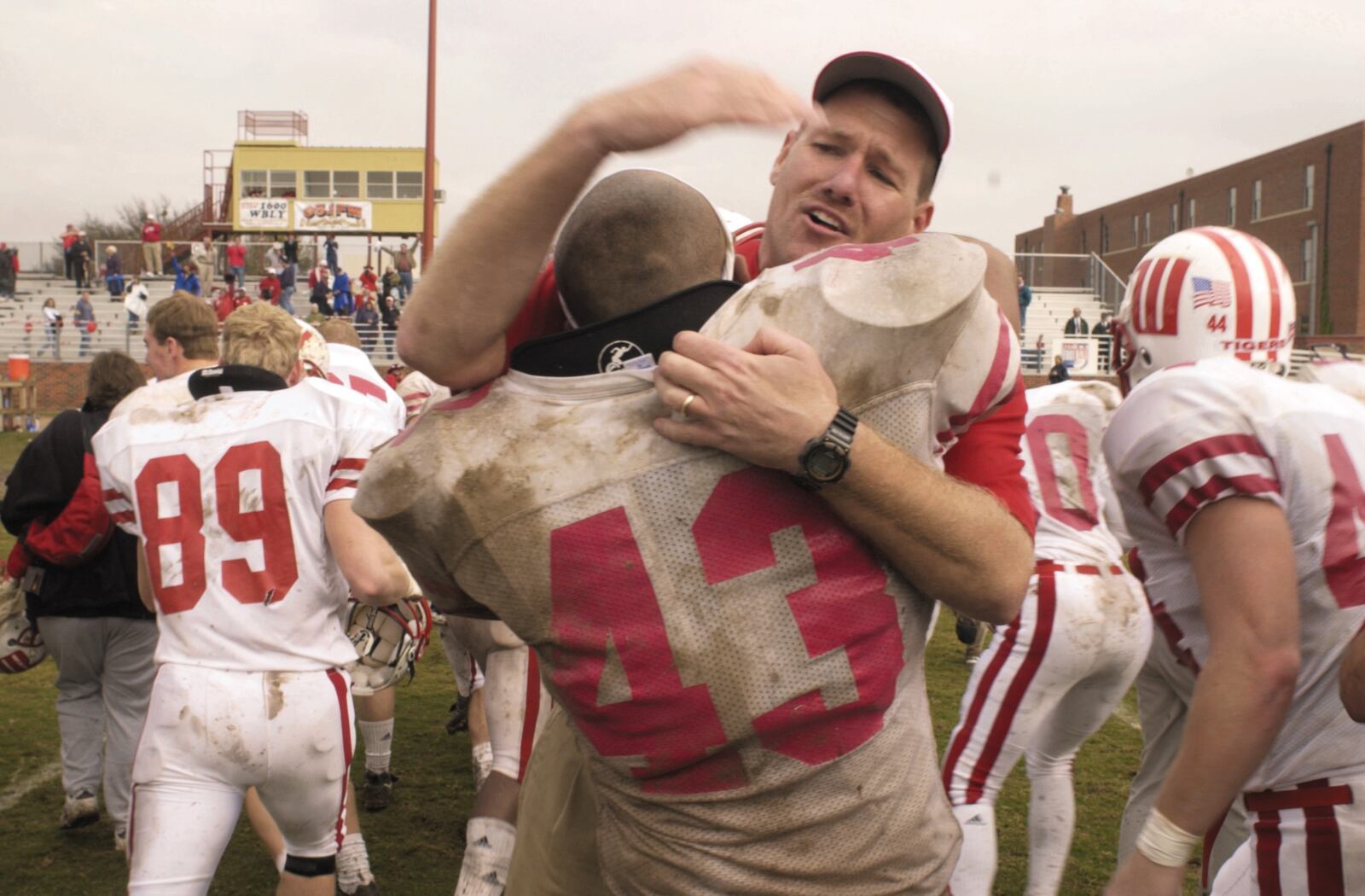 Wittenberg head coach Joe Finchams hugs linebacker Ryan Gresham following one of the biggest victories of his career, a 38-35 defeat of Hardin-Simmons in the first round of the NCAA Division III playoffs in 2001 in Abilene, Texas. Contributed photo