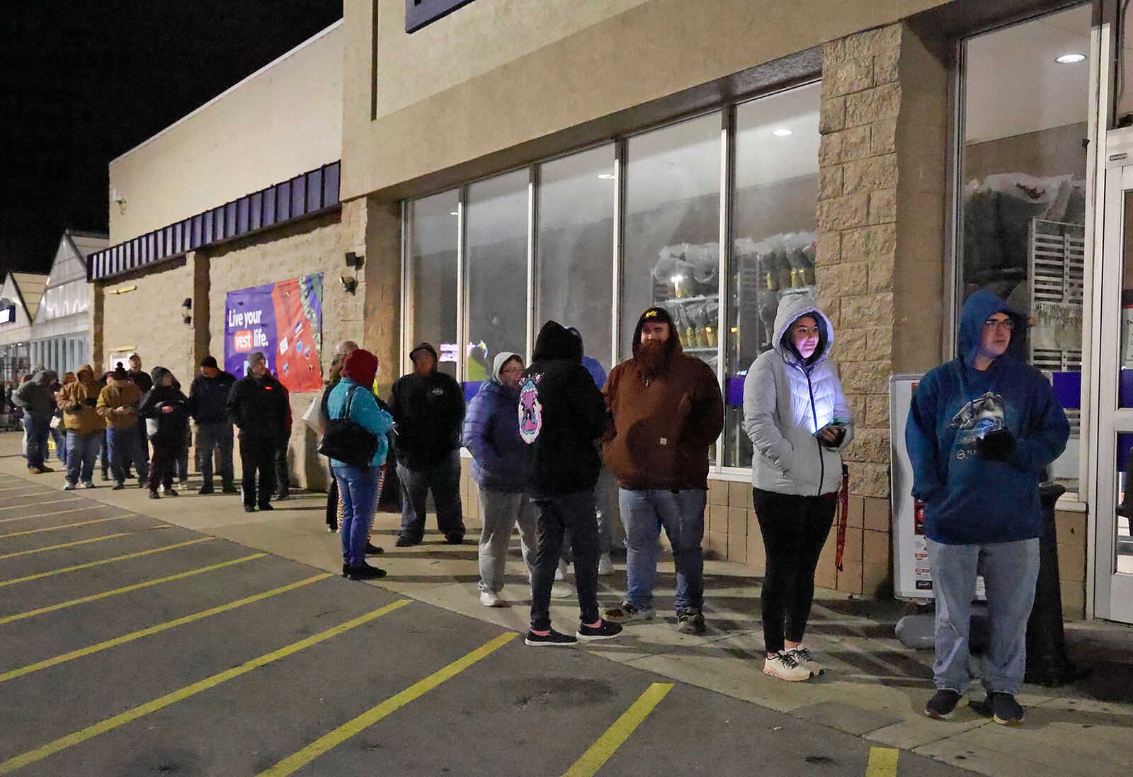 Shoppers wait in line outside Lowe's on North Bechtle Avenue for the store to open on Black Friday. BILL LACKEY/STAFF