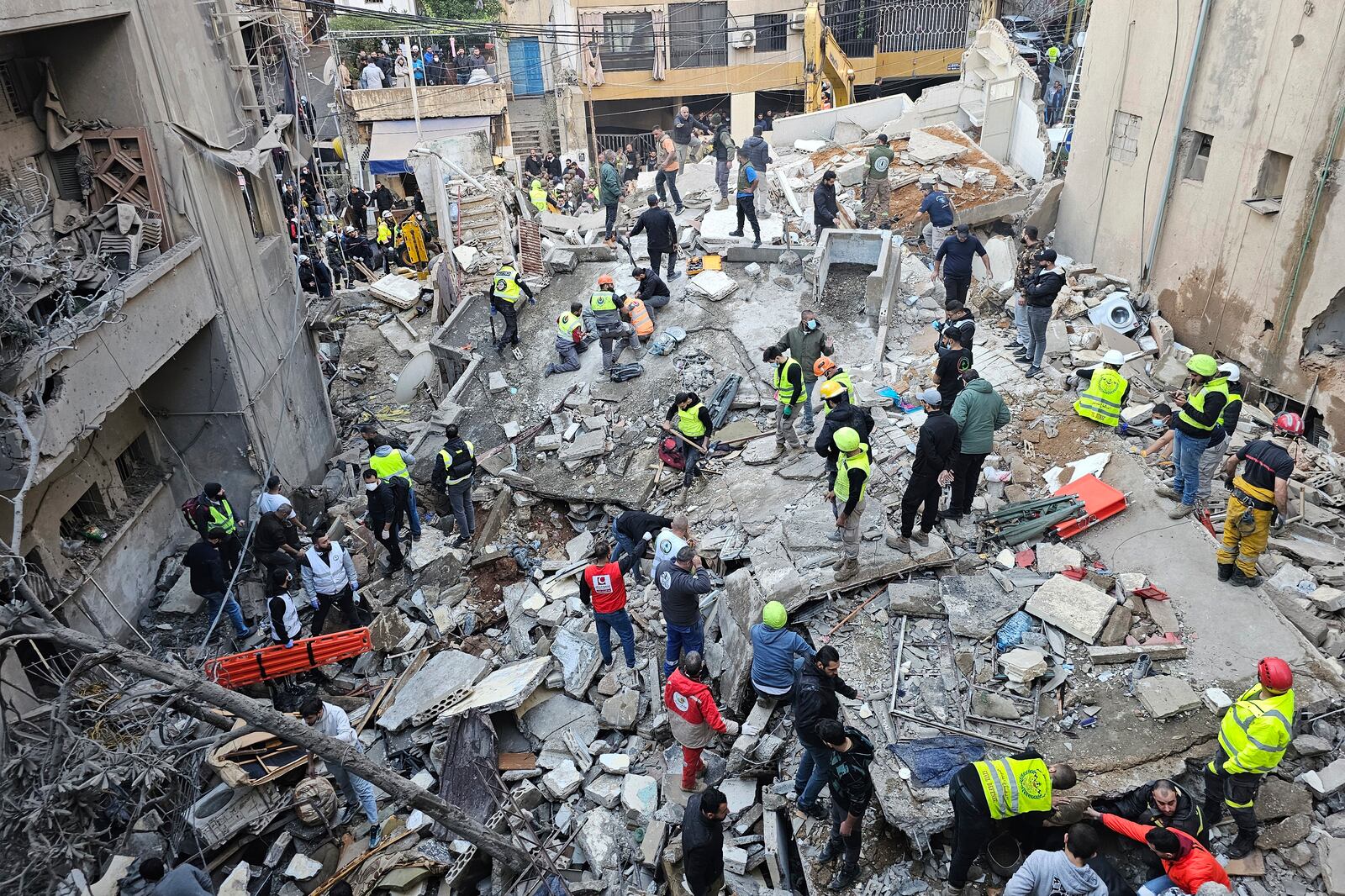 Rescuers search for victims at the site of an Israeli airstrike that targeted a building in Beirut, Lebanon, Tuesday, Nov. 26, 2024. (AP Photo/Hassan Ammar)