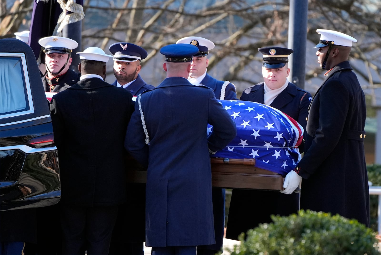 The casket of former President Jimmy Carter is placed into the hearse by a joint services body bearer team from the Jimmy Carter Presidential Library and Museum in Atlanta, Tuesday, Jan. 7, 2025. Carter died Dec. 29 at the age of 100. (AP Photo/Alex Brandon, Pool)