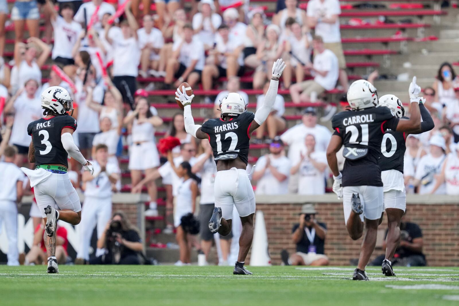 Cincinnati cornerback Justin Harris (12) celebrates after intercepting a pass during the second half of an NCAA college football game against Eastern Kentucky, Saturday, Sept. 2, 2023, in Cincinnati. (AP Photo/Aaron Doster)