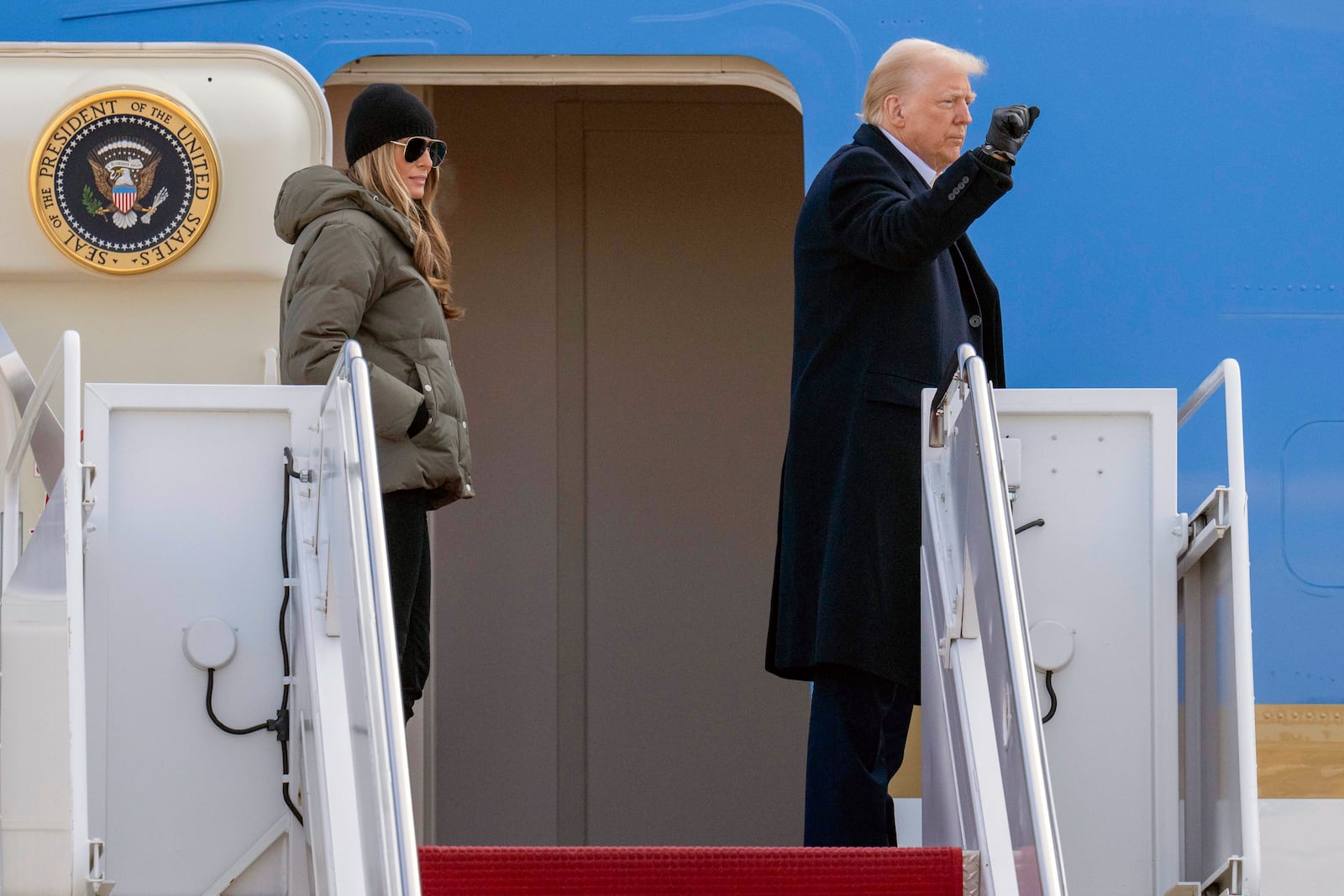 President Donald Trump and first lady Melania Trump wave as they board Air Force One at Joint Base Andrews, Md., Friday, Jan. 24, 2025, en route to Asheville, N.C. (AP Photo/Jess Rapfogel)