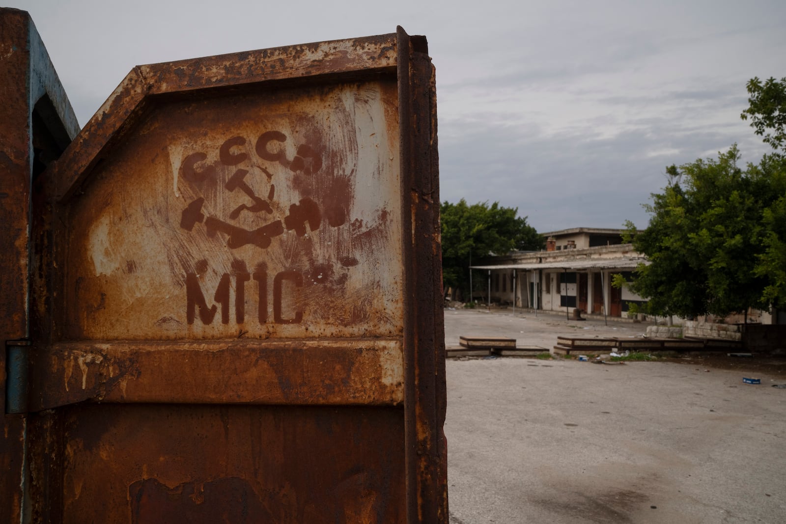 A Soviet Union symbol is seen on a old small container at the entrance of a Syrian Navy area in the port of Latakia, Syria, Monday, Dec. 16, 2024. (AP Photo/Leo Correa)