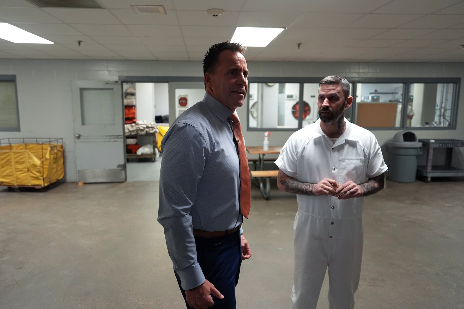 Genesee County Sheriff Chris Swanson talks with an inmate at the county jail, Jan. 28, 2025 in Flint, Mich. (AP Photo/Paul Sancya)