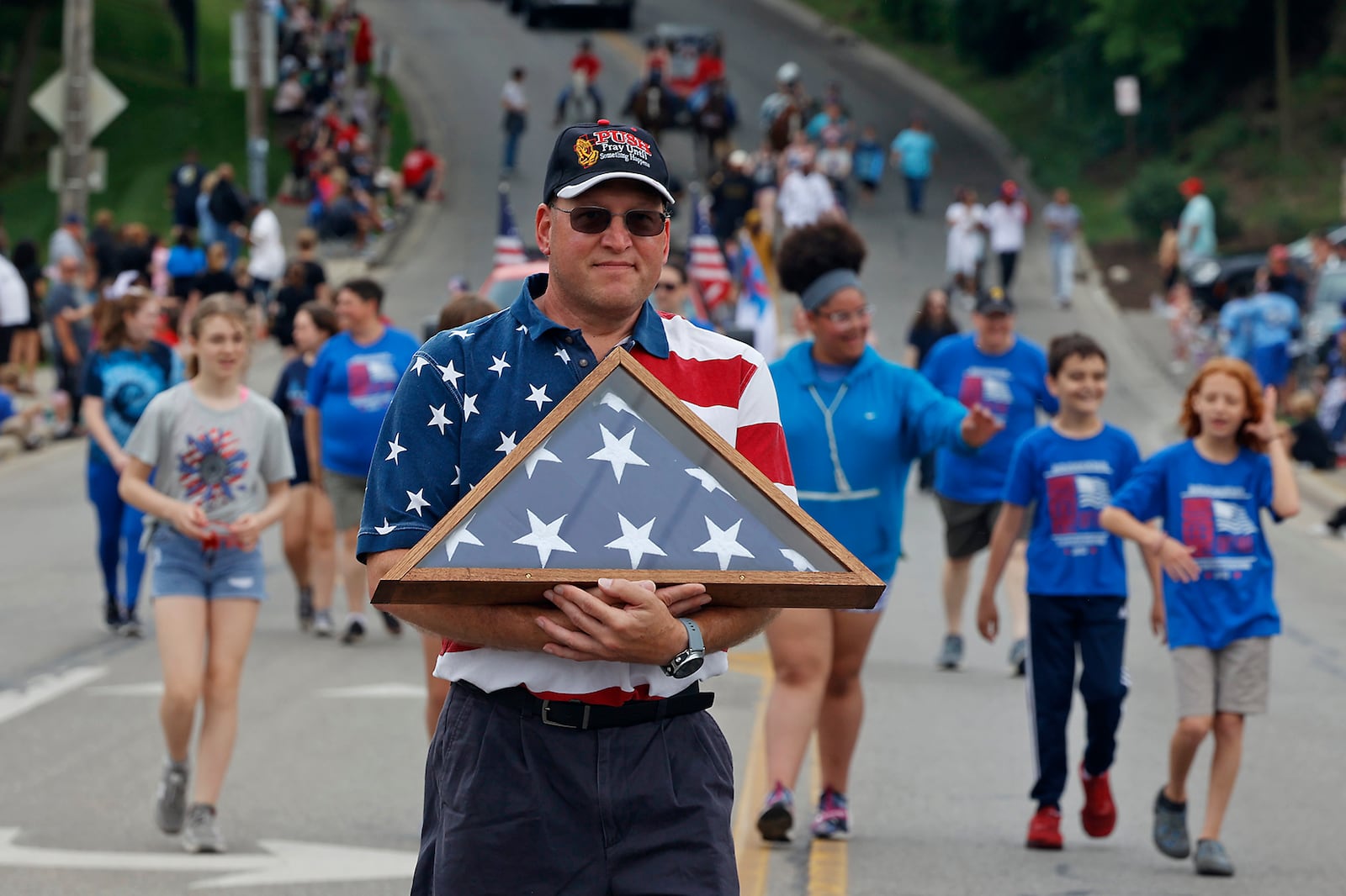 Hundreds of people put on their best red, white and blue attire and came out to watch the Springfield Memorial Day Monday, May 27, 2024. Men, women and children waved American flags and cheered as the parade marched by with veterans, flags, firetrucks and bands paying tribute to the nations fallen service men and women. BILL LACKEY/STAFF 