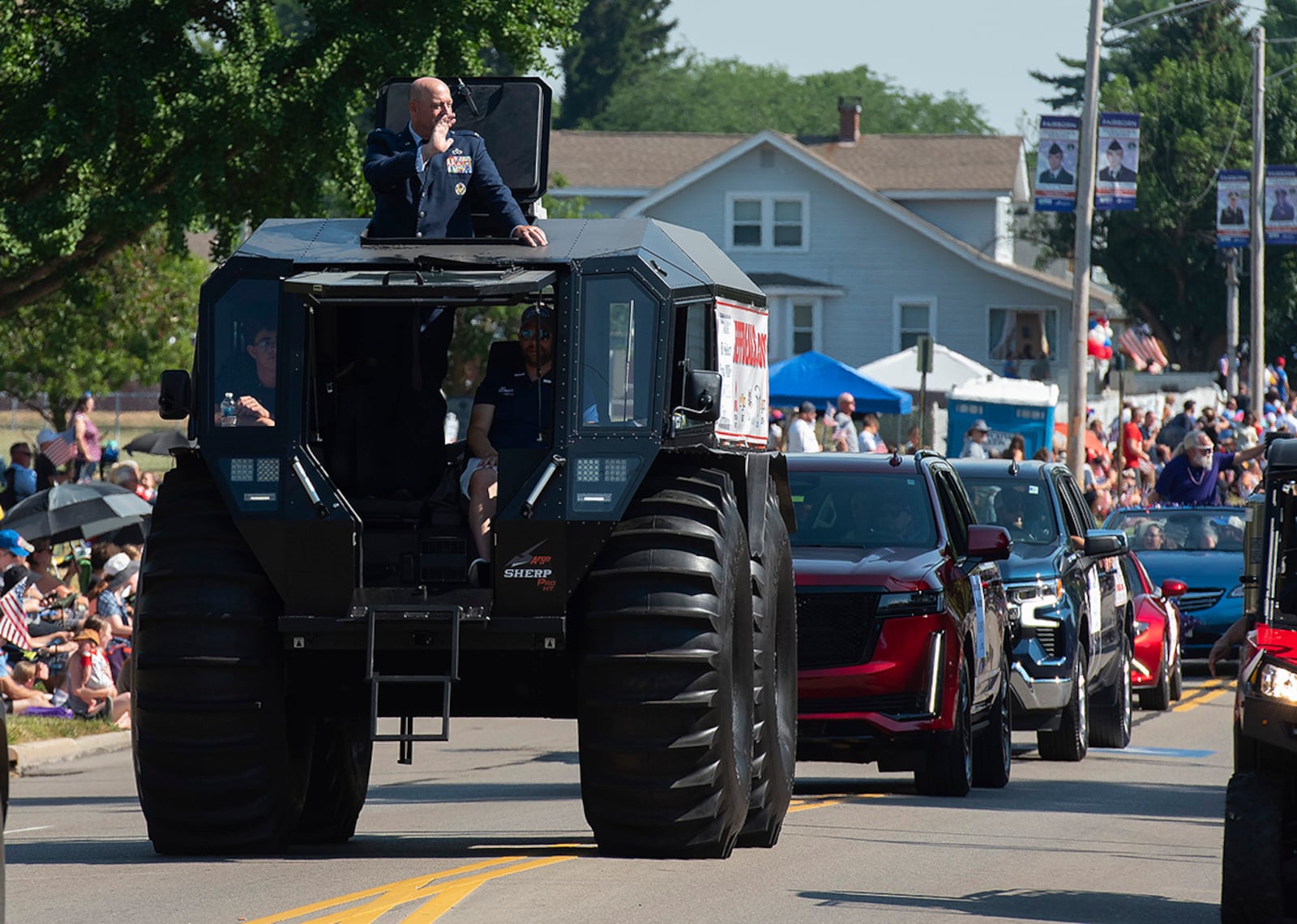 Col. Patrick Miller, then-88th Air Base Wing and Wright-Patterson Air Force Base commander, waves to spectators from a Sherp utility task vehicle at the lead of the Fairborn Fourth of July parade. The local community invited the wing’s commander, vice command and command chief to ride at the front of the parade. U.S. AIR FORCE PHOTO/R.J. ORIEZ