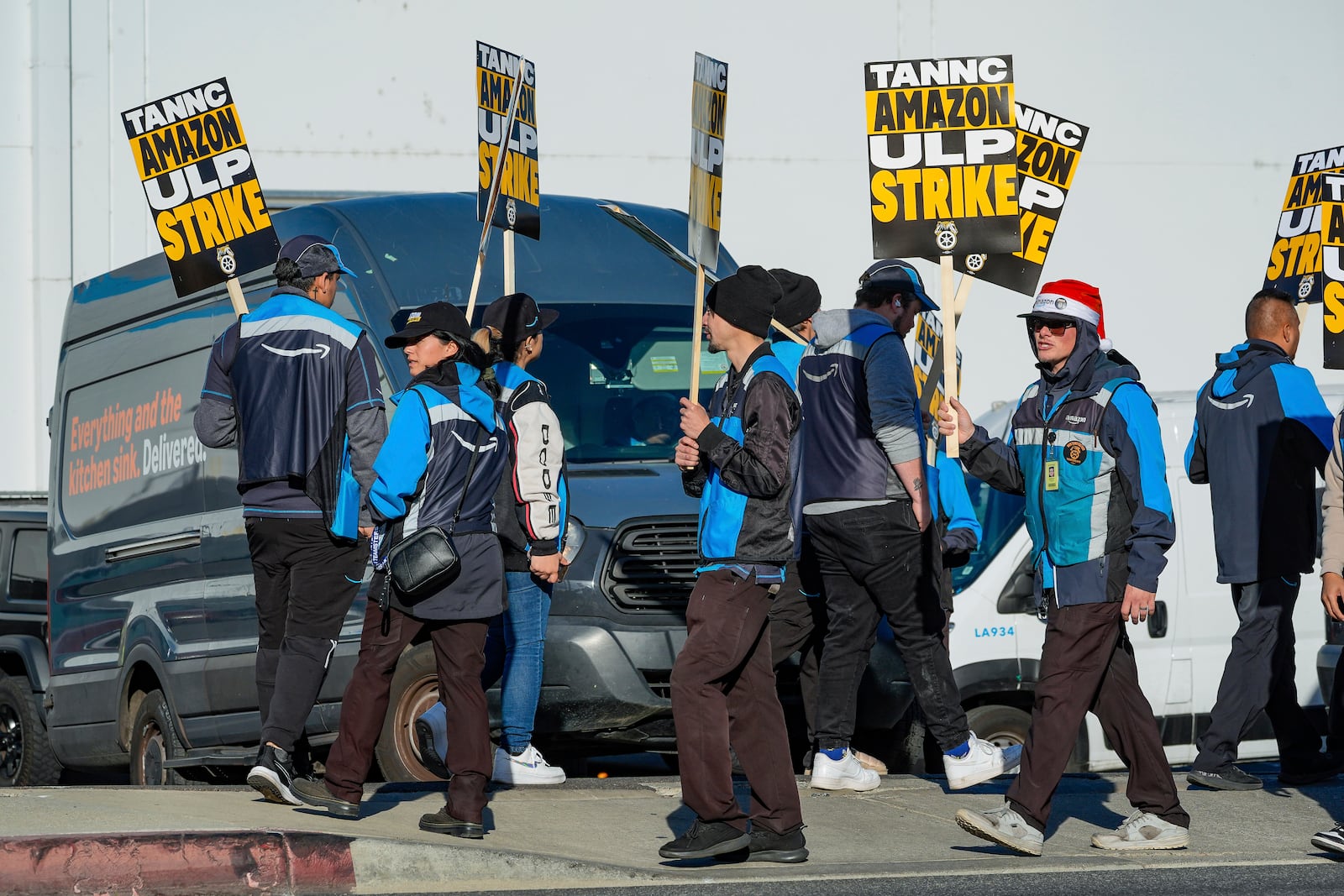 Amazon workers strike outside the gates of an Amazon Fulfillment Center as Teamsters seek labor contract nationwide Thursday, Dec. 19, 2024, in City of Industry, Calif. (AP Photo/Damian Dovarganes)