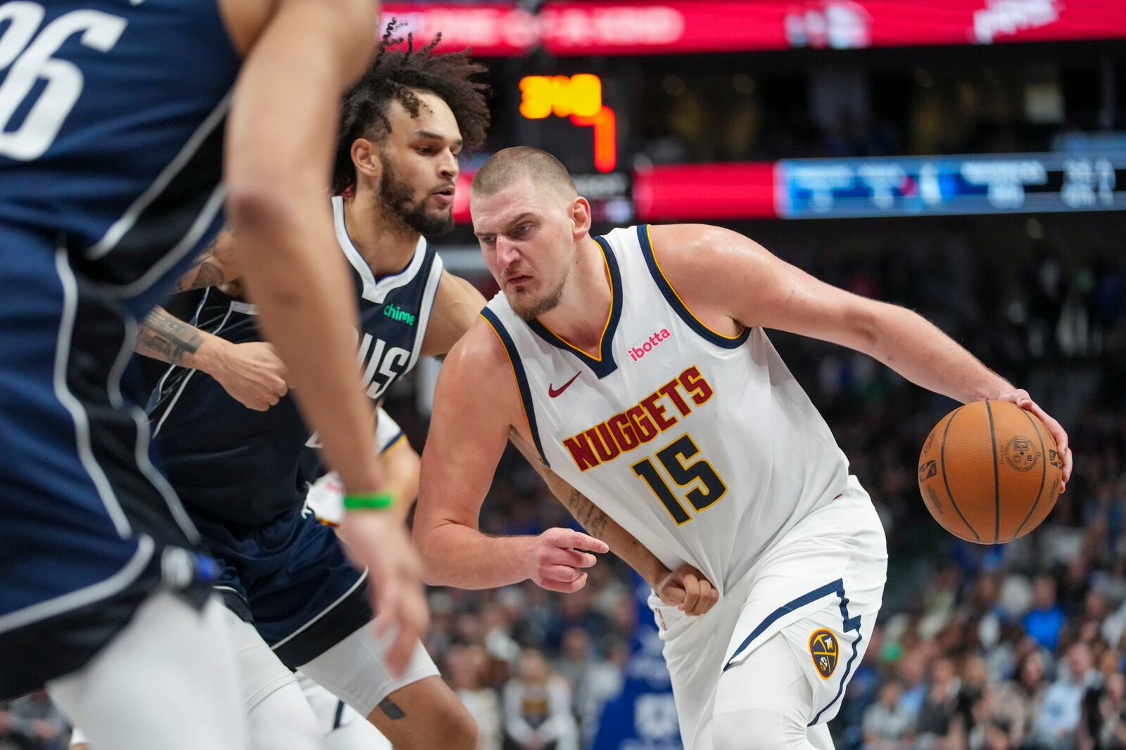 Denver Nuggets center Nikola Jokic (15) drives against Dallas Mavericks center Dereck Lively II during the second half of an NBA basketball game, Sunday, Jan. 12, 2025, in Dallas. The Nuggets won 112-101. (AP Photo/Julio Cortez)