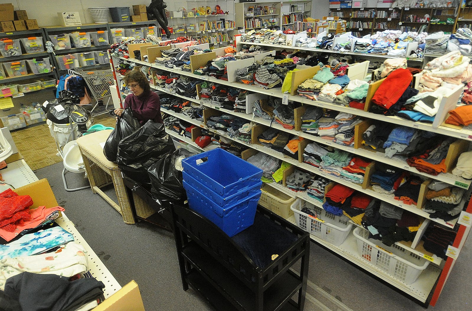 Janet Zabudske stocks shelves at Hannah's Treasure Chest in Centerville Thursday, Jan. 25, 2024 . The nonprofit purchased a 36,000-square-foot building at 2490 Technical Drive in Miamisburg this month for nearly $1.7 million. MARSHALL GORBY/STAFF