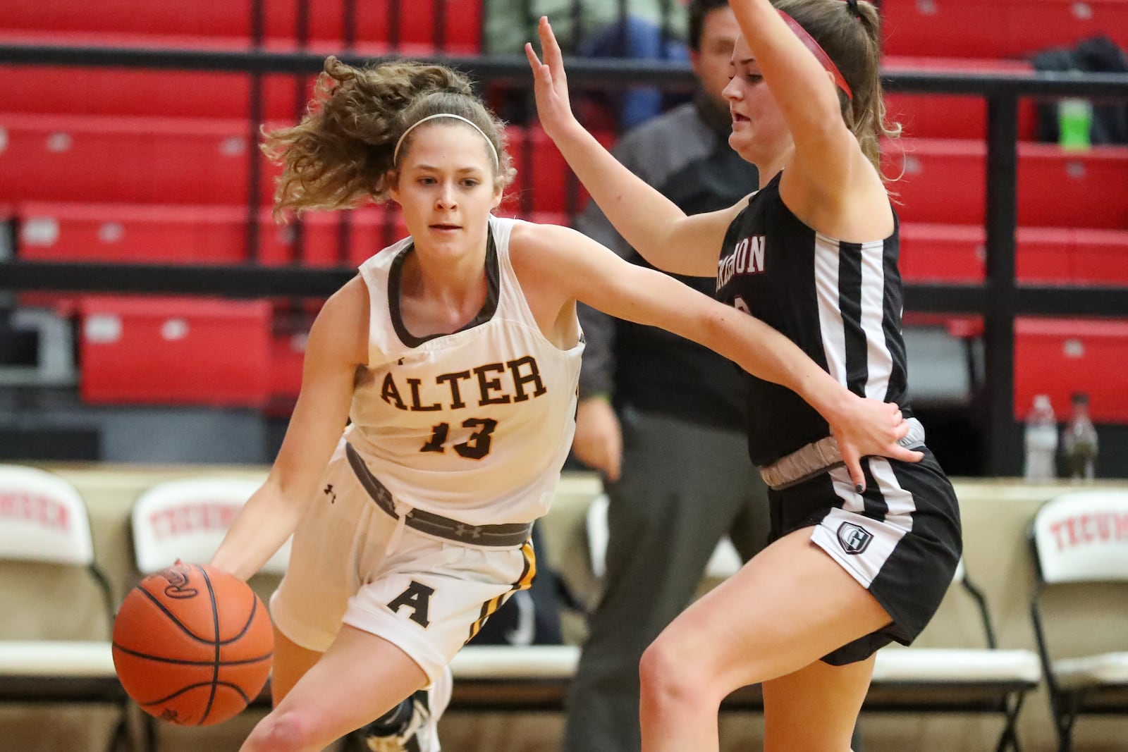 Alter High School junior Hannah Mayse drives past Greenon sophomore Avery Minteer during their D-II district semifinal game on Thursday night at Tecumseh High School. CONTRIBUTED PHOTO BY MICHAEL COOPER