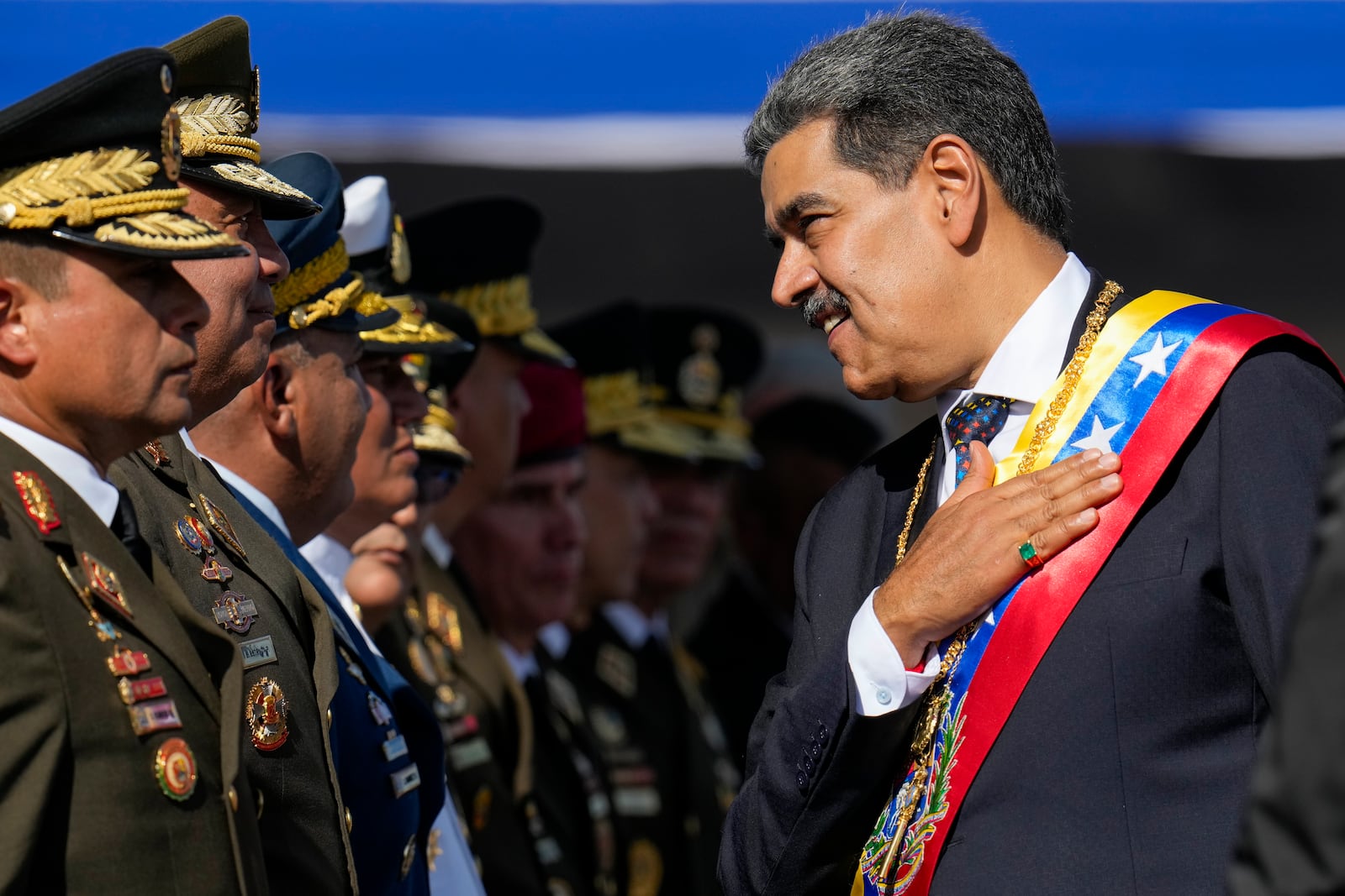 Venezuela's President Nicolas Maduro talks to high-ranking officers during a military ceremony on his inauguration day for a third term in Caracas, Venezuela, Friday, Jan. 10, 2025. (AP Photo/Ariana Cubillos)