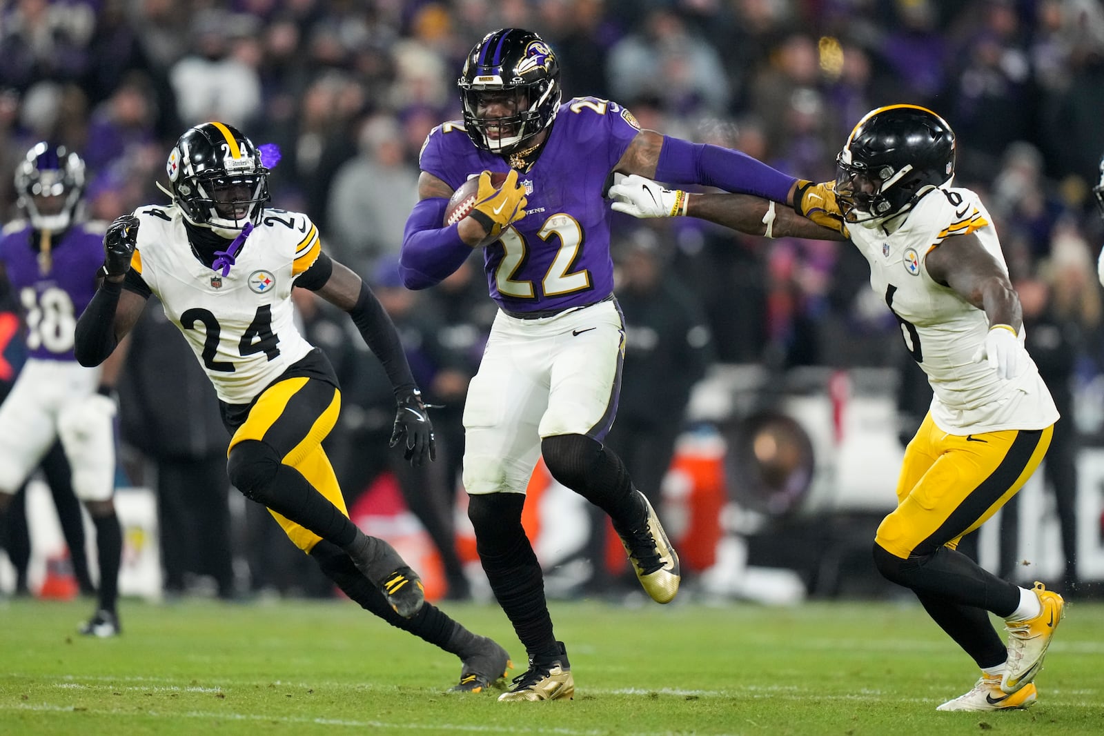 Baltimore Ravens running back Derrick Henry (22) breaks away from Pittsburgh Steelers linebacker Patrick Queen (6) and cornerback Joey Porter Jr. (24) on his way to scoring a rushing touchdown during the second half of an NFL wild-card playoff football game, Saturday, Jan. 11, 2025, in Baltimore. (AP Photo/Stephanie Scarbrough)