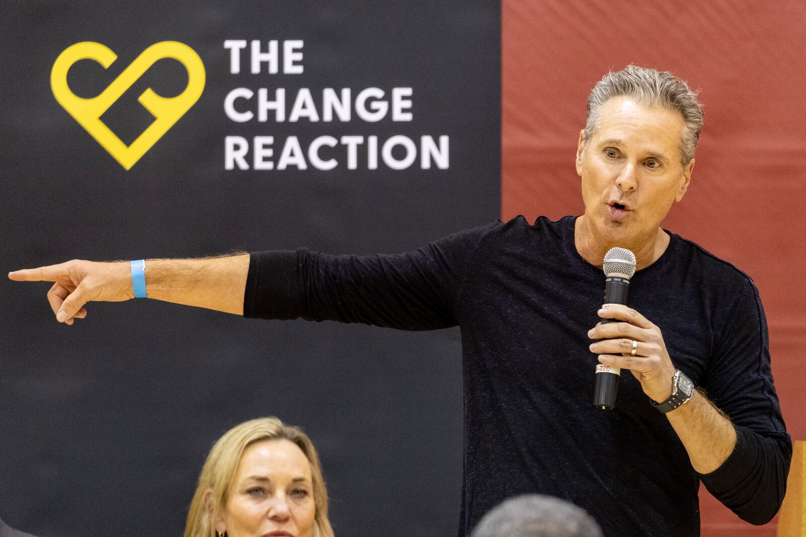 The Change Reaction founder Greg Perlman delivers a speech as he attends an event at the gymnasium of Pasadena City College where The Change Reaction will be handing out about 1,000 checks of between $2,500-$5,000 to people impacted by the Eaton Fire, Tuesday, Jan. 28, 2025 in Pasadena, Calif. (AP Photo/Etienne Laurent)