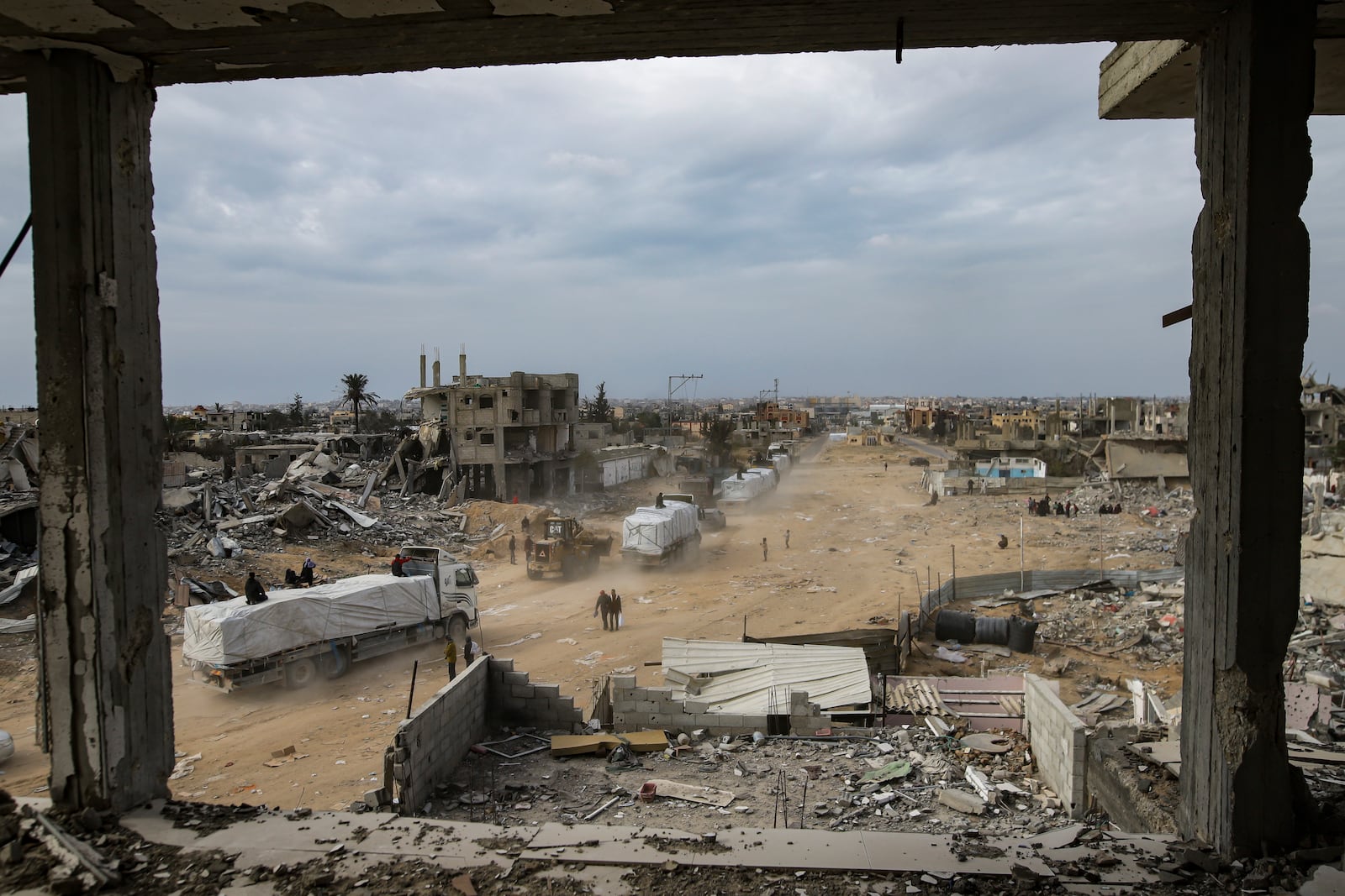 Humanitarian aid trucks enter through the Kerem Shalom crossing from Egypt into the Gaza Strip, in Rafah, Wednesday, Jan. 22, 2025, days after the ceasefire deal between Israel and Hamas came into effect. (AP Photo/Jehad Alshrafi)