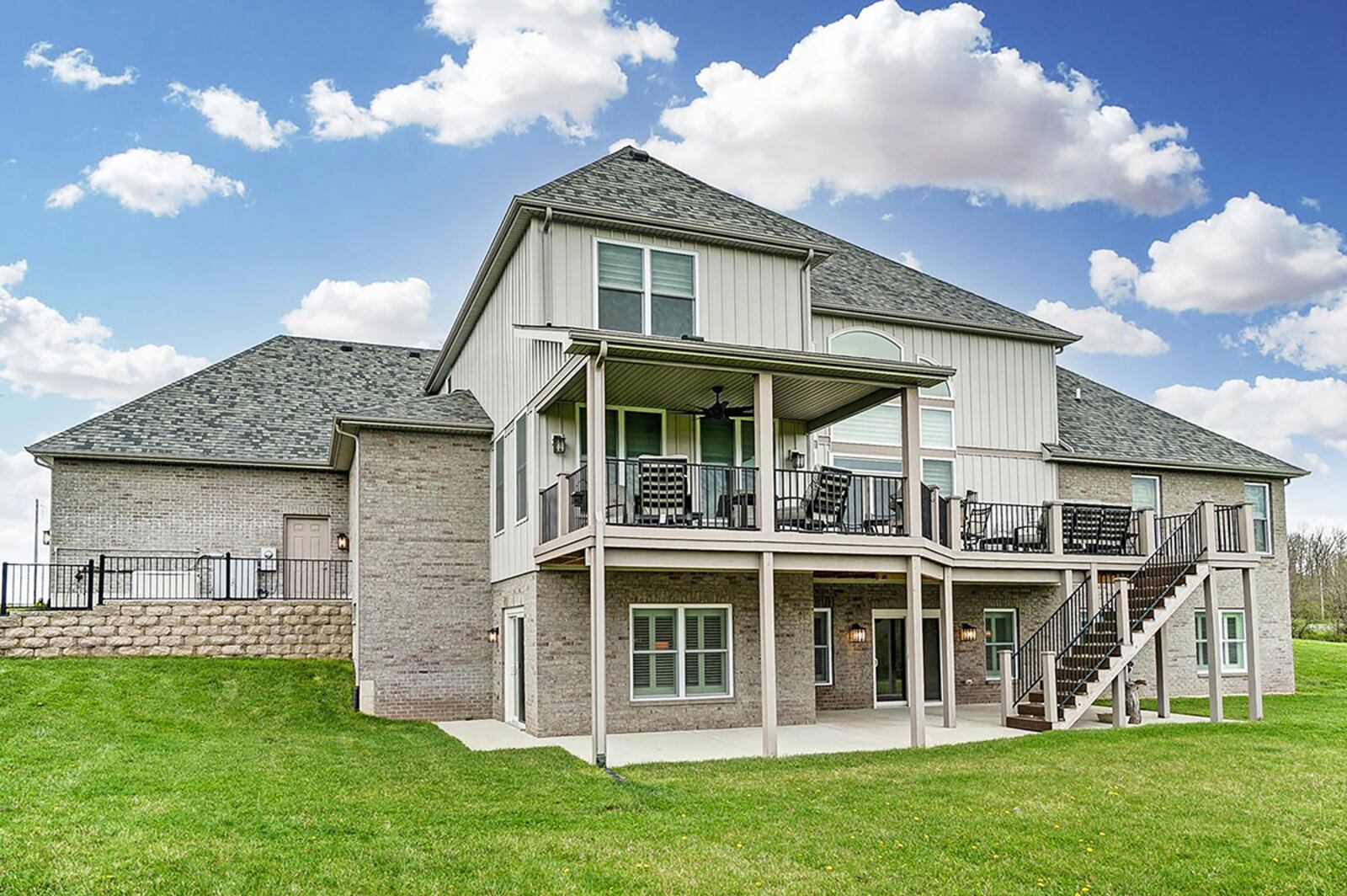 An upper-level composite deck is partially covered with a railing surrounding it. The walk-out basement leads to a stamped concrete patio on the lower level. CONTRIBUTED PHOTO