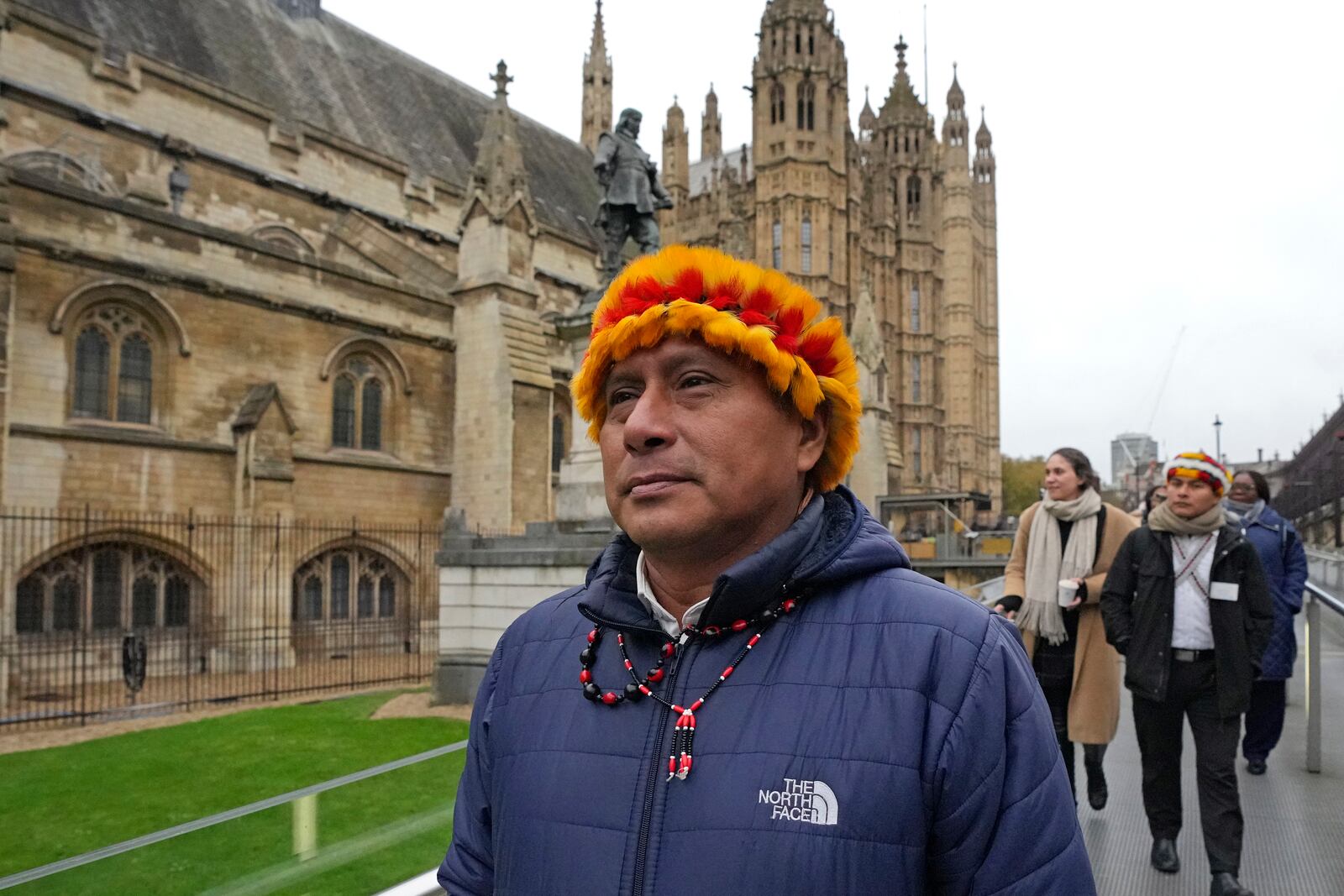 Indigenous leaders from the Wampis Nation in Peru, Pamuk Teofilo Kukush Pati, left, and Tsanim Evaristo Wajai Asamat, back right, arrive the House of Parliament in London, Thursday, Nov. 21, 2024. (AP Photo/Kin Cheung)