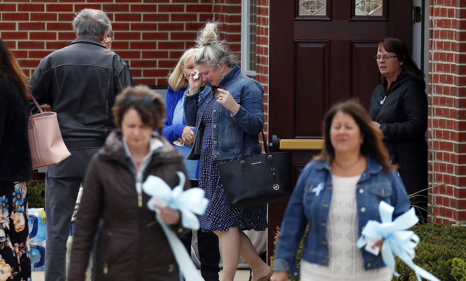 Mourners wipe away tears May 3, 2019, as they leave visitation services for Andrew "AJ" Freund Jr., 5, at Davenport Funeral Home in Crystal Lake, Ill. AJ’S parents, Andrew Freund Sr., 60, and JoAnn Cunningham, 36, face multiple charges, including five counts of first-degree murder, in his April 15 death. The boy, who was reported missing from the family's home April 18, 2019, was found wrapped in plastic and buried in a shallow grave six days later.