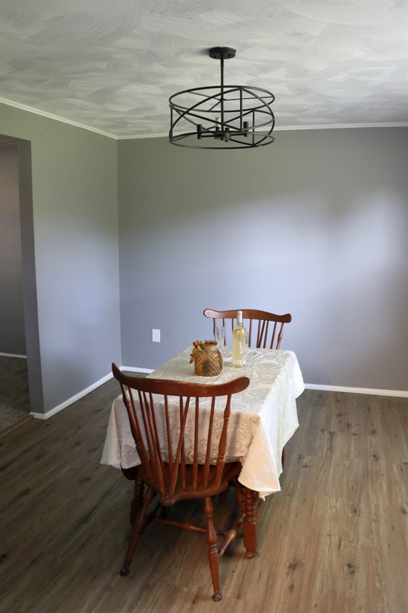 The dining room has double rear-facing windows and has access to the kitchen.