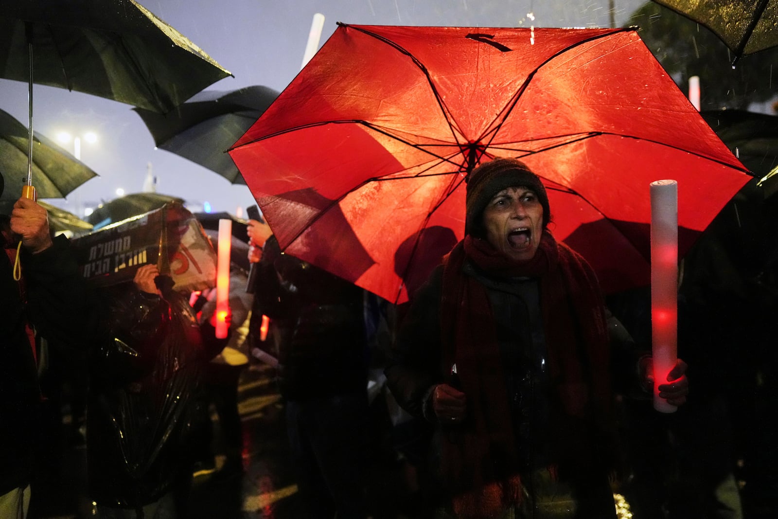 Israelis attend a rally against Prime Minister Benjamin Netanyahu's plan to dismiss the head of the Shin Bet internal security service, and calling for the release of hostages held by Hamas in the Gaza Strip, outside the Knesset, Israel's parliament in Jerusalem on Thursday, March 20, 2025. (AP Photo/Ohad Zwigenberg)