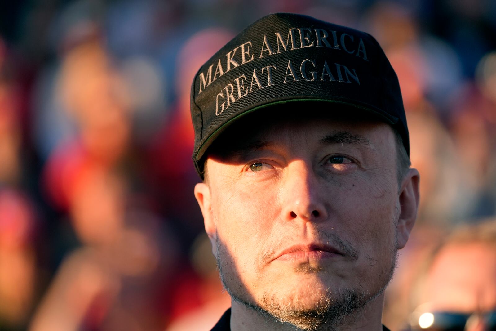 FILE - Tesla and SpaceX CEO Elon Musk listens as Republican presidential nominee former President Donald Trump speaks at a campaign event at the Butler Farm Show, Oct. 5, 2024, in Butler, Pa. (AP Photo/Alex Brandon, File)