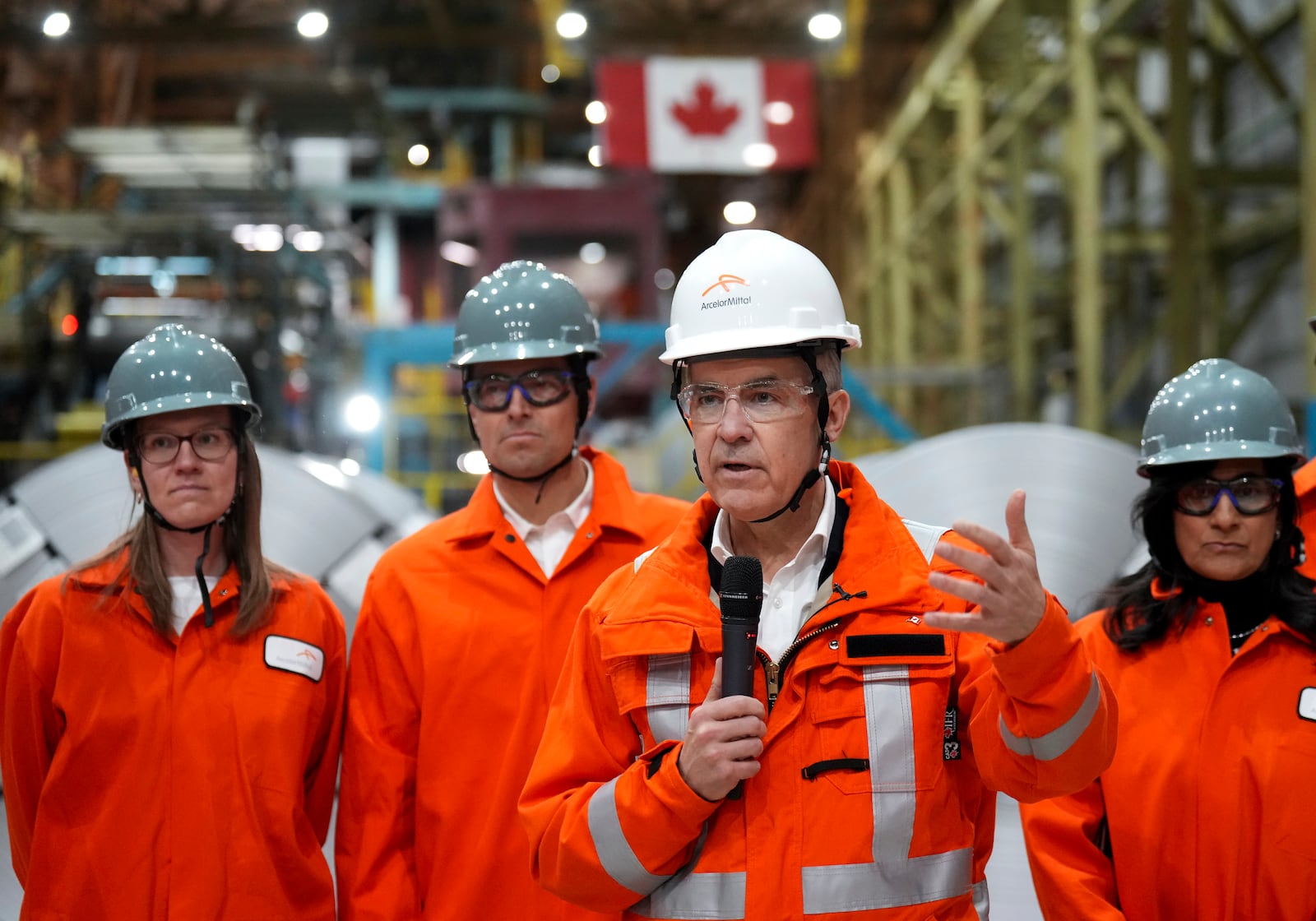 Canadian Prime Minister designate Mark Carney, second right, speaks to steel workers after touring the ArcelorMittal Dofasco steel plant in Hamilton, Ont., on Wednesday, March 12, 2025. (Nathan Denette /The Canadian Press via AP)