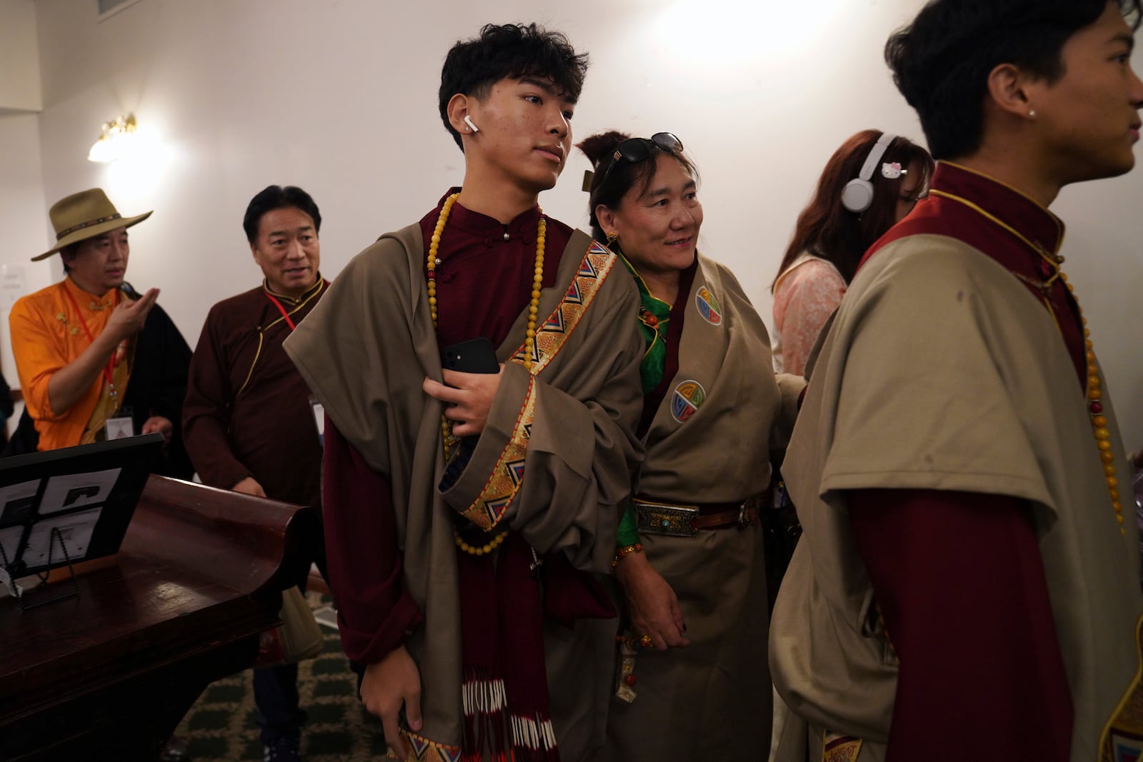 Friends, family, and community members attend the 18th birthday and enthronement ceremony of U.S.-born Buddhist lama, Jalue Dorje, at the Tibetan American Foundation of Minnesota in Isanti, Minn., on Saturday, Nov. 9, 2024. (AP Photo/Jessie Wardarski)