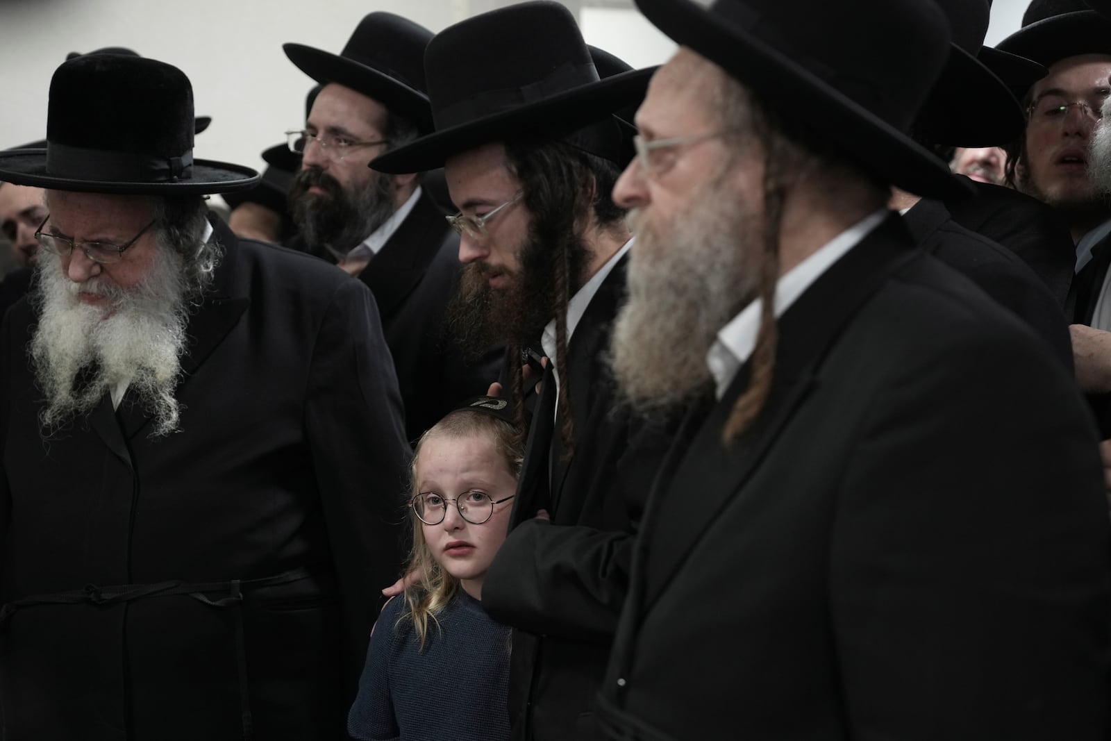 Ultra-Orthodox Jewish mourners gather for the funeral of Yehoshua Aharon Tuvia Simcha, 12, fatally shot by a gunman who opened fire on a bus, in Jerusalem, Thursday, Dec. 12, 2024. (AP Photo/Mahmoud Illean)