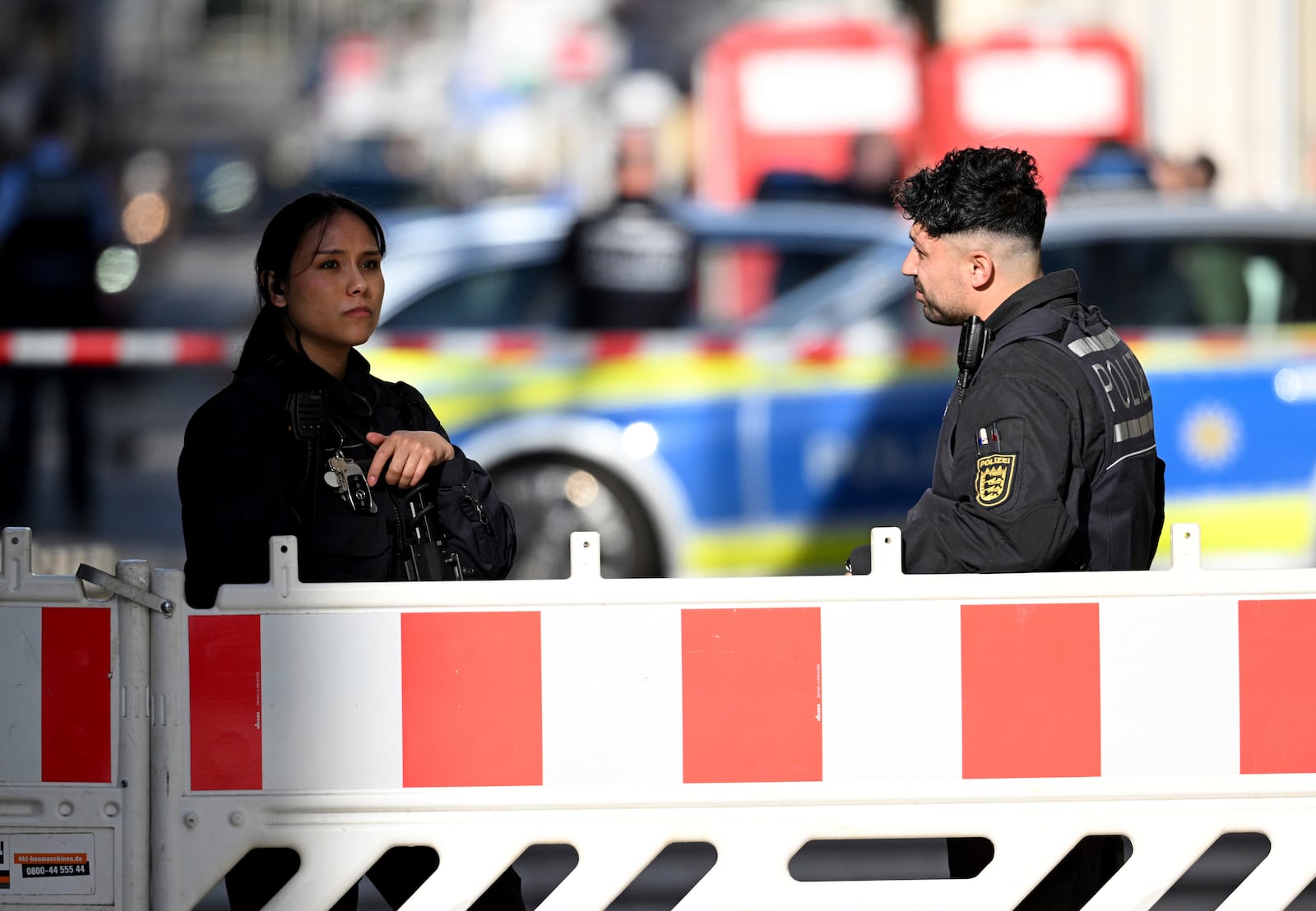 Police officers secure a street in the city center of Mannheim, Germany, Monday March 3, 2025, following an incident in which one person was killed and others injured when a car rammed into a crowd, German police said. (Boris Roessler/dpa via AP)