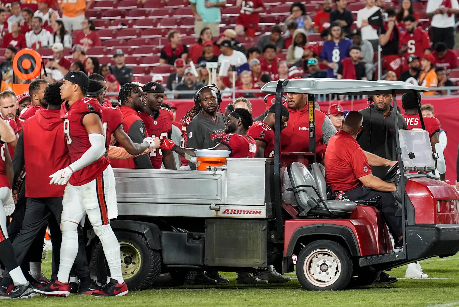 Tampa Bay Buccaneers wide receiver Chris Godwin (14) interacts with his teammates while being carted off of the field after an injury during the second half of an NFL football game against the Baltimore Ravens, Monday, Oct. 21, 2024, in Tampa, Fla. (AP Photo/Chris O'Meara)