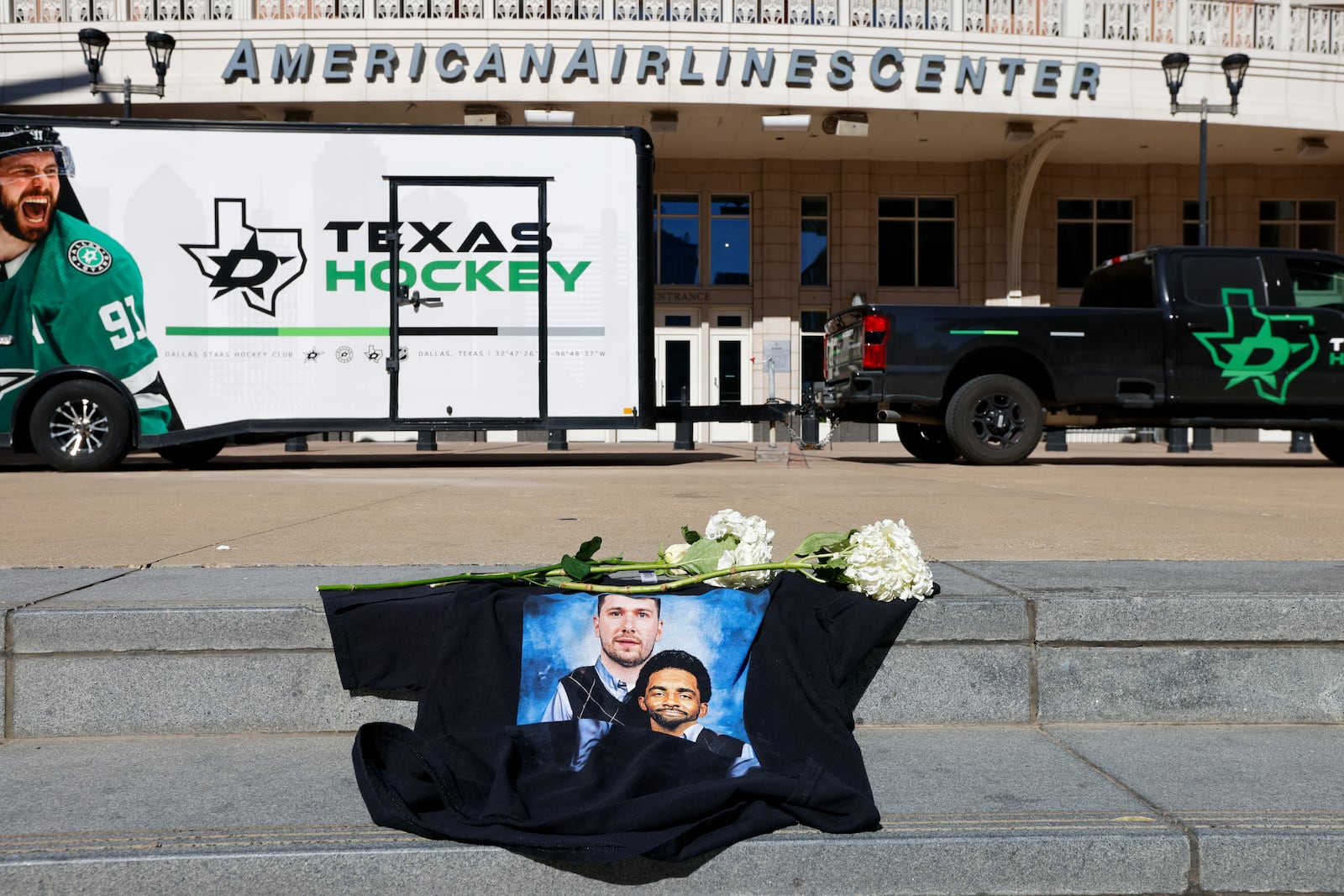 Flowers and a shirt with a photo of Dallas Mavericks' Luka Doncic and Kyrie Irving sits on the steps outside the American Airlines Center after Doncic was traded to the Los Angeles Lakers, Sunday, Feb. 2, 2025, in Dallas. (Elias Valverde II/The Dallas Morning News via AP)