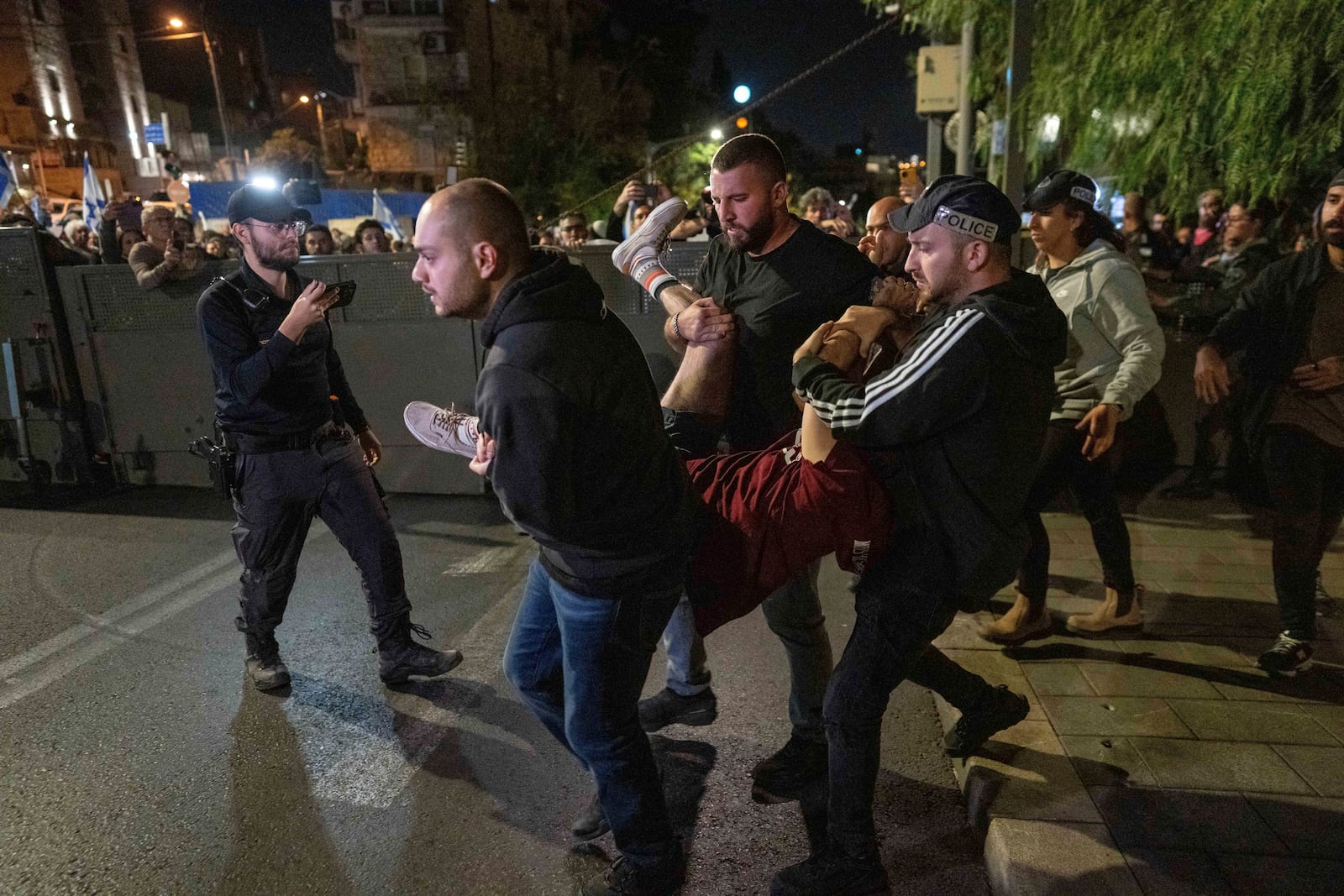 Police disperse people protesting against Prime Minister Benjamin Netanyahu's near his residence in Jerusalem after he has dismissed his defense minister Yoav Gallant in a surprise announcement, Tuesday, Nov. 5, 2024. (AP Photo/Ohad Zwigenberg)