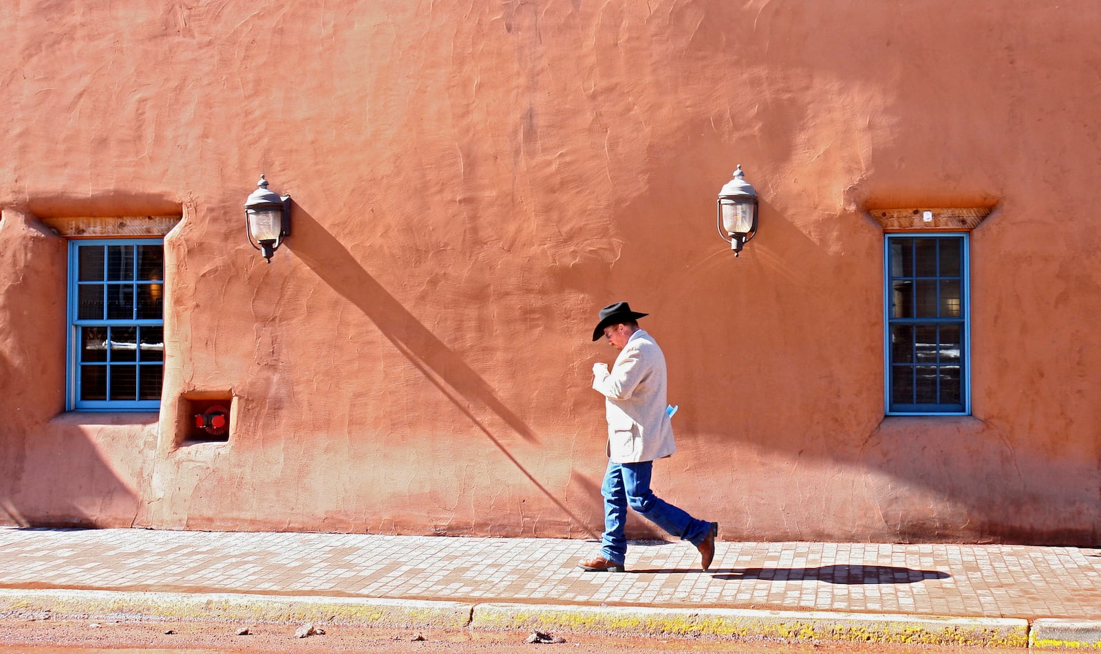 FILE - A man walks through downtown Santa Fe, N.M., Feb. 15, 2007. (AP Photo/The New Mexican, Amiran White, File)