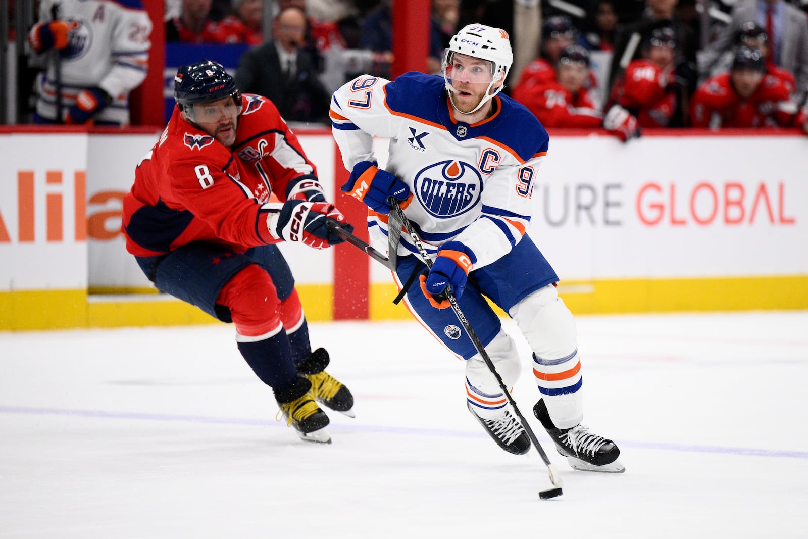 Edmonton Oilers center Connor McDavid (97) skates with the puck past Washington Capitals left wing Alex Ovechkin (8) during the second period of an NHL hockey game, Sunday, Feb. 23, 2025, in Washington. (AP Photo/Nick Wass)