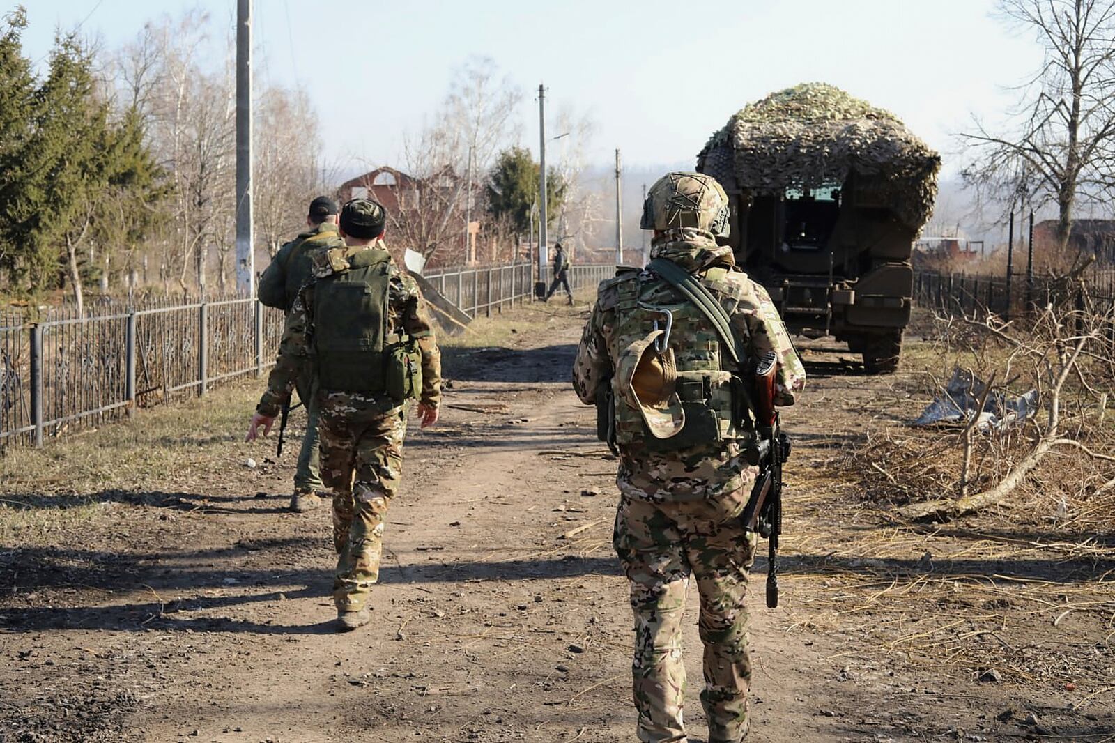 In this photo taken from video distributed by Russian Defense Ministry Press Service on Friday, March 14, 2025, Russian soldiers patrol an area in the Kursk region of Russia after it was taken over by Russian troops. (Russian Defense Ministry Press Service via AP)