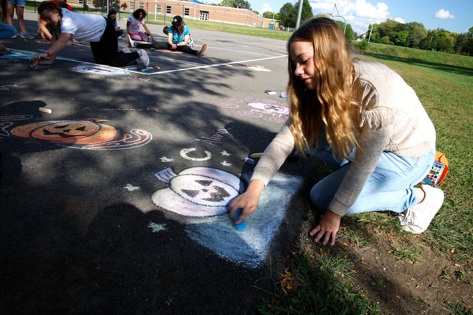 Alivia Penwell works on a chalk drawing of a pumpkin Wednesday, Sept. 13, 2023 as she participates in the Lets Chalk About It event at Davey Moore Park. The workshop, held by Project Jericho and the National Trail Park and Recreation District, was meant to give people a chance to learn some basic chalk drawing techniques and get local artists of all skill levels interested in ChalkFest being held in October at National Road Commons park. BILL LACKEY/STAFF