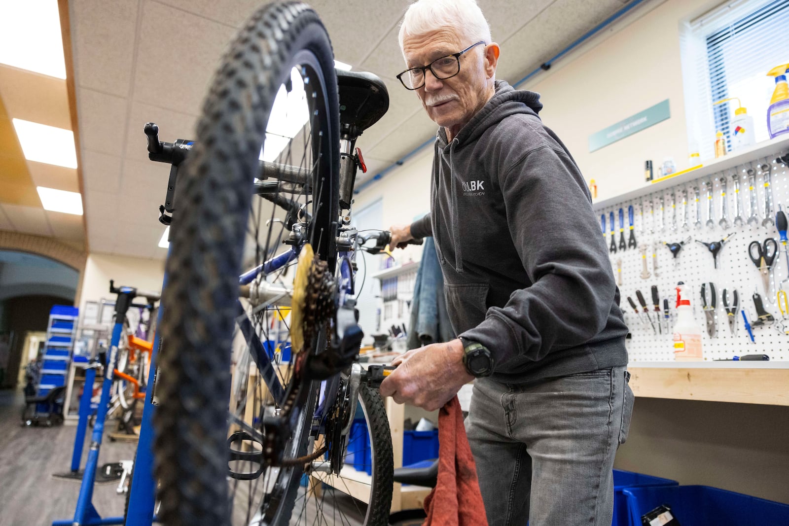 Volunteer Clayton Streich fixes a bicycle at Lincoln Bike Kitchen on Tuesday, Nov. 12, 2024, in Lincoln, Neb. (AP Photo/Rebecca S. Gratz)