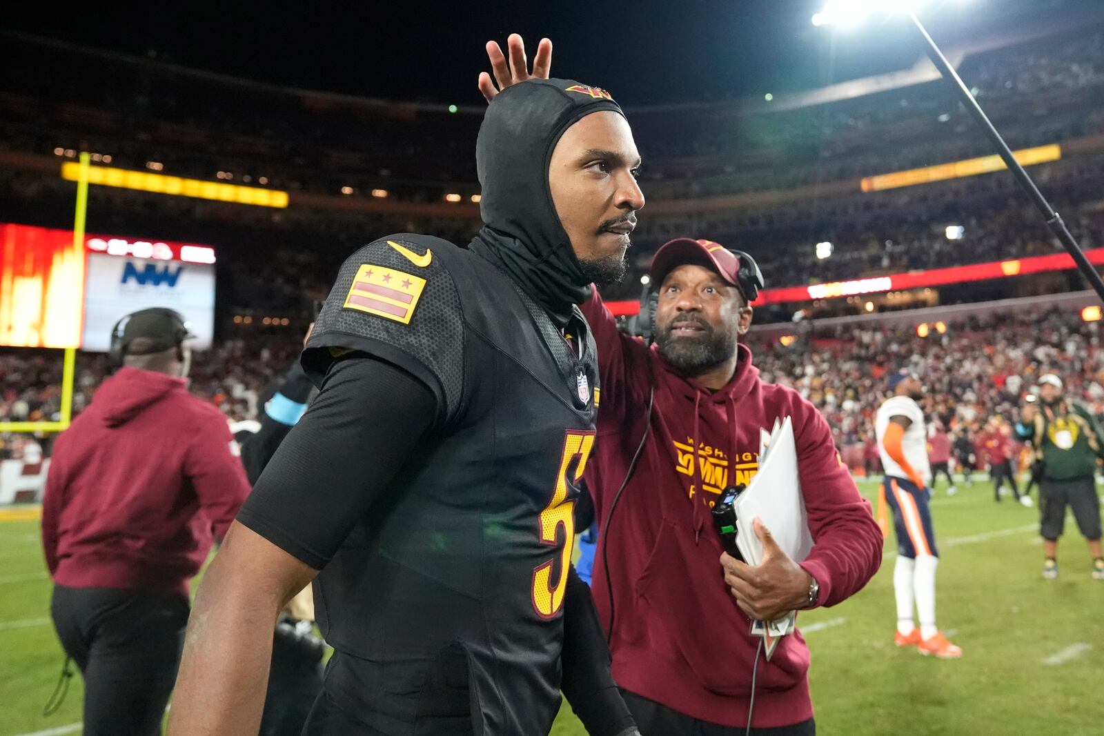 Washington Commanders quarterback Jayden Daniels (5) leaves the field after an 18-15 win over the Chicago Bears in an NFL football game Sunday, Oct. 27, 2024, in Landover, Md. (AP Photo/Stephanie Scarbrough)